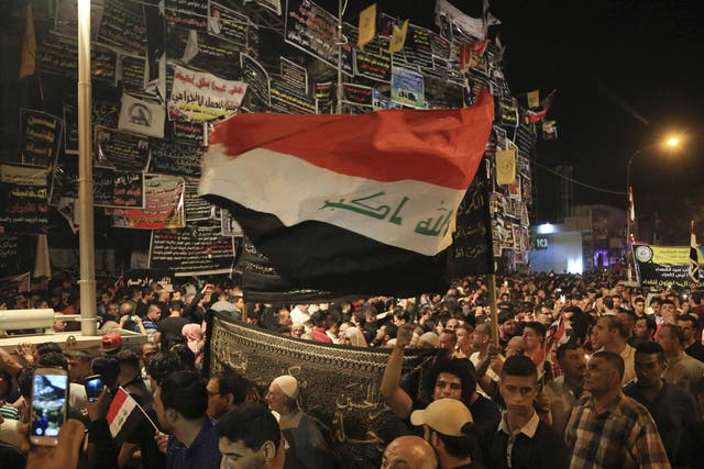 People gather to pay their respects to those killed in a bombing in Baghdad, which Isis said it was responsible for