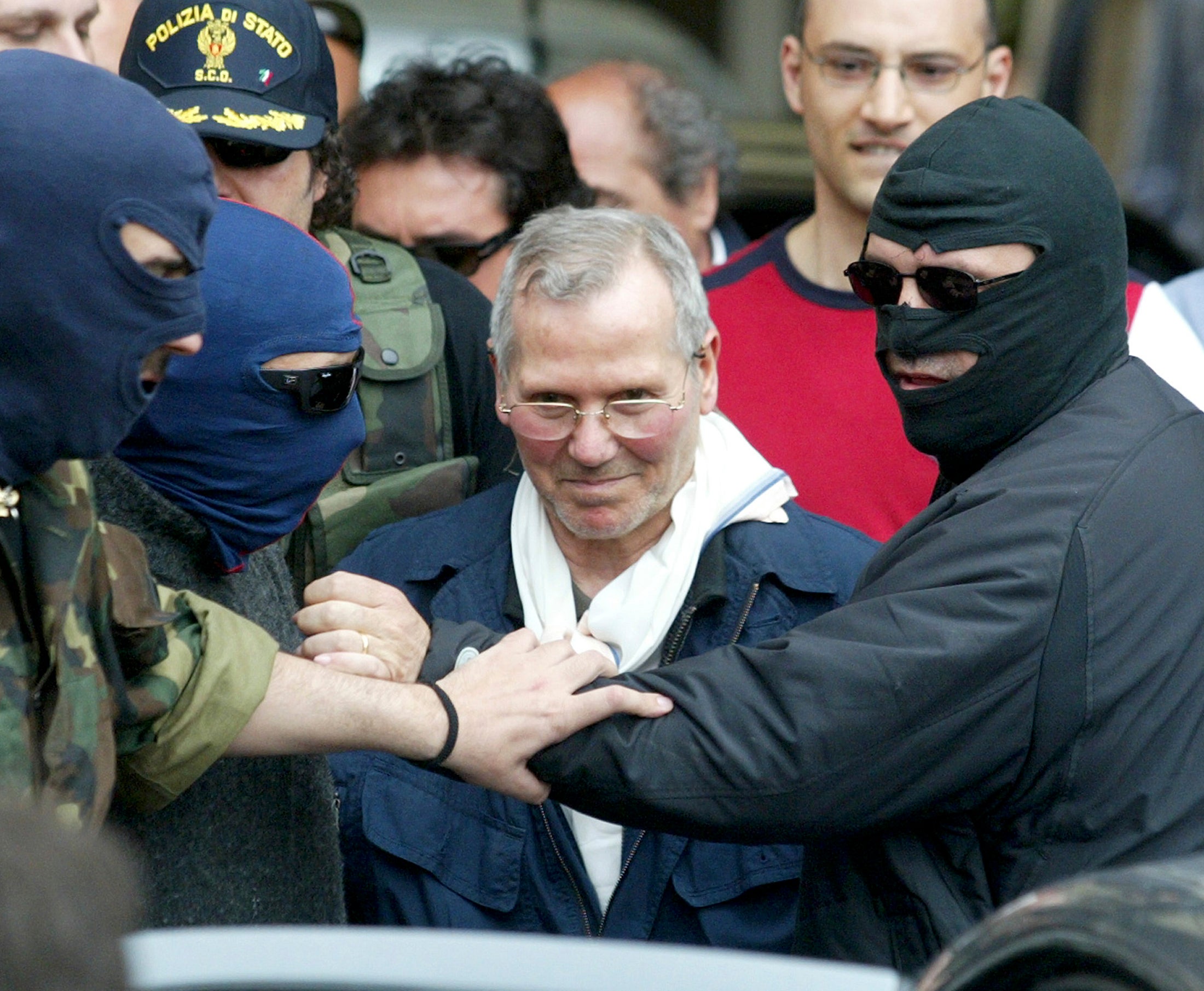 Police officers lead Bernardo Provenzano from a police station in Palermo in 2006