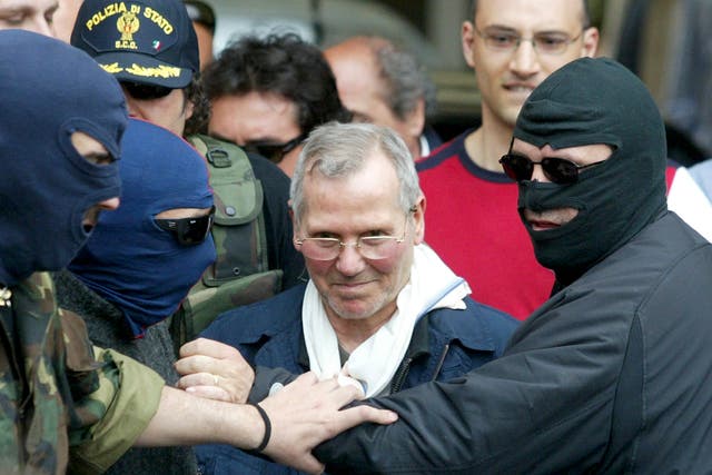 Police officers lead Bernardo Provenzano from a police station in Palermo in 2006