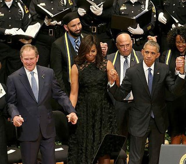 Mr Bush appears to be dancing during the memorial