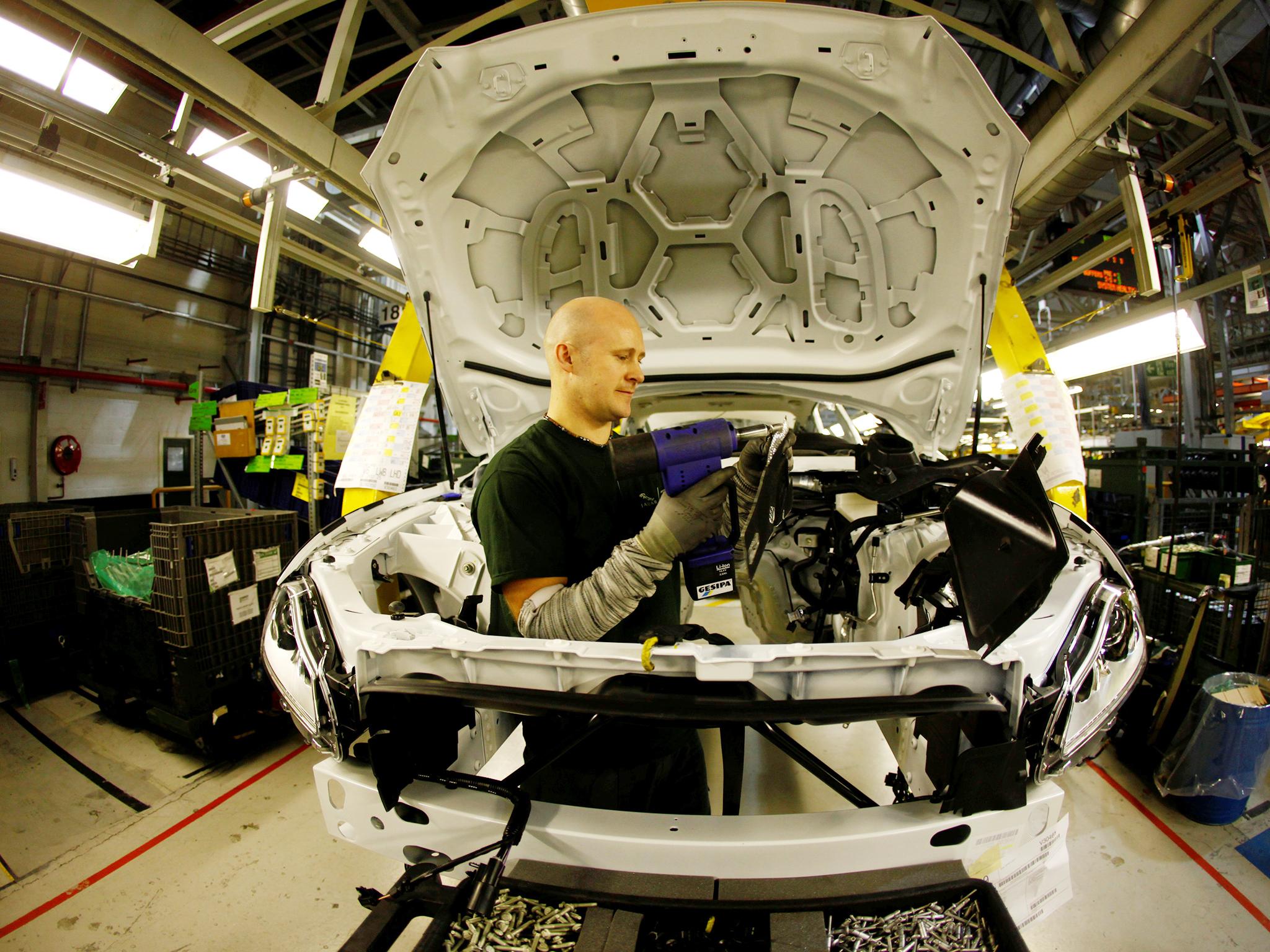 Staff work on the Jaguar XJ production line at Castle Bromwich Assembly Plant