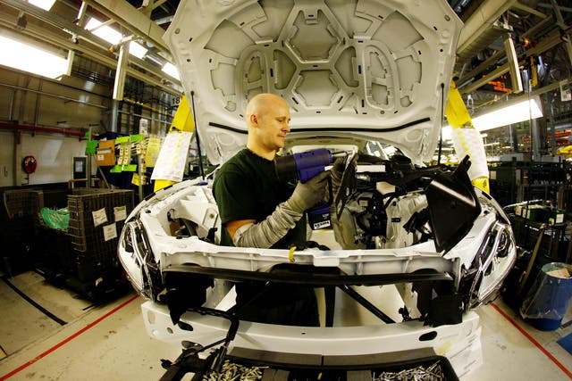 Staff work on the Jaguar XJ production line at Castle Bromwich Assembly Plant