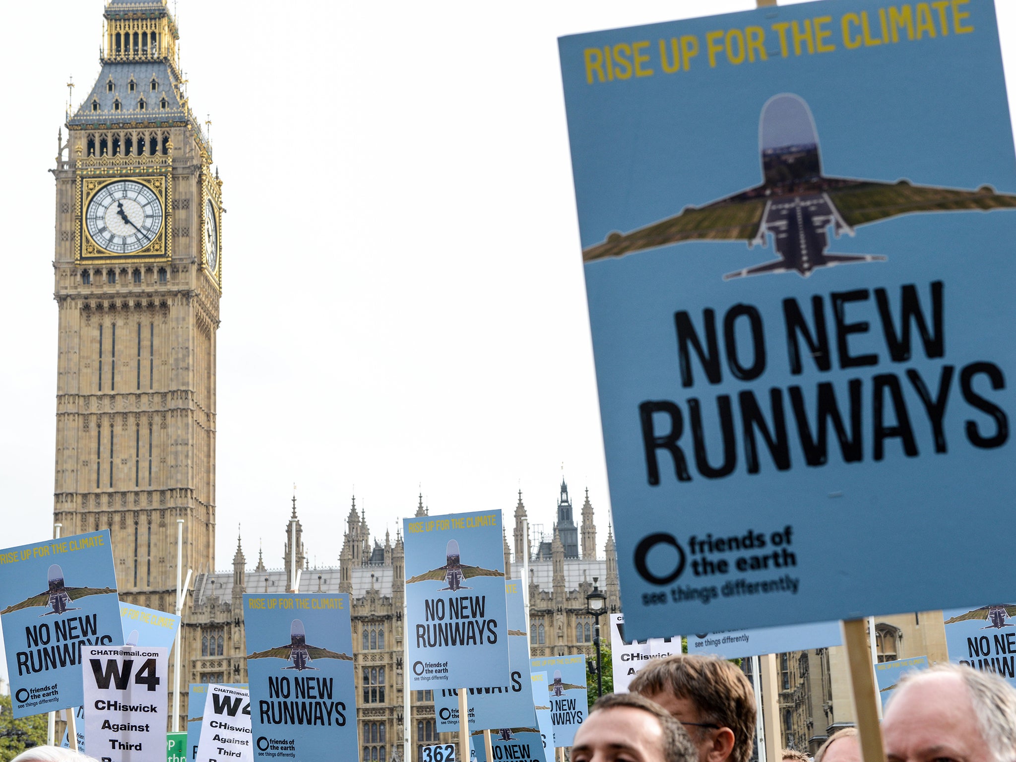 &#13;
Protesters hold signs during a rally against a third runway at Heathrow last year &#13;