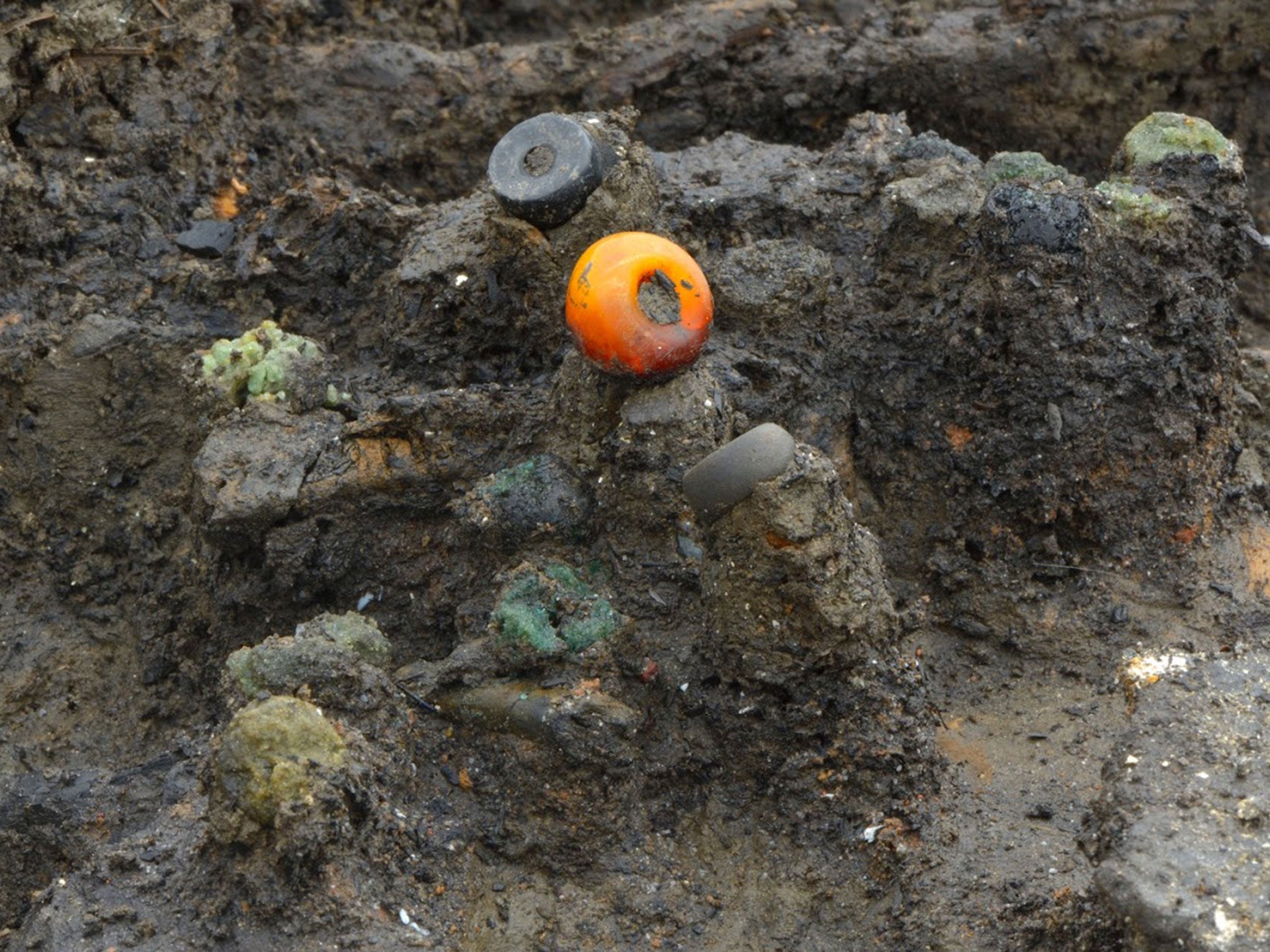 Amber bead and others found in situ