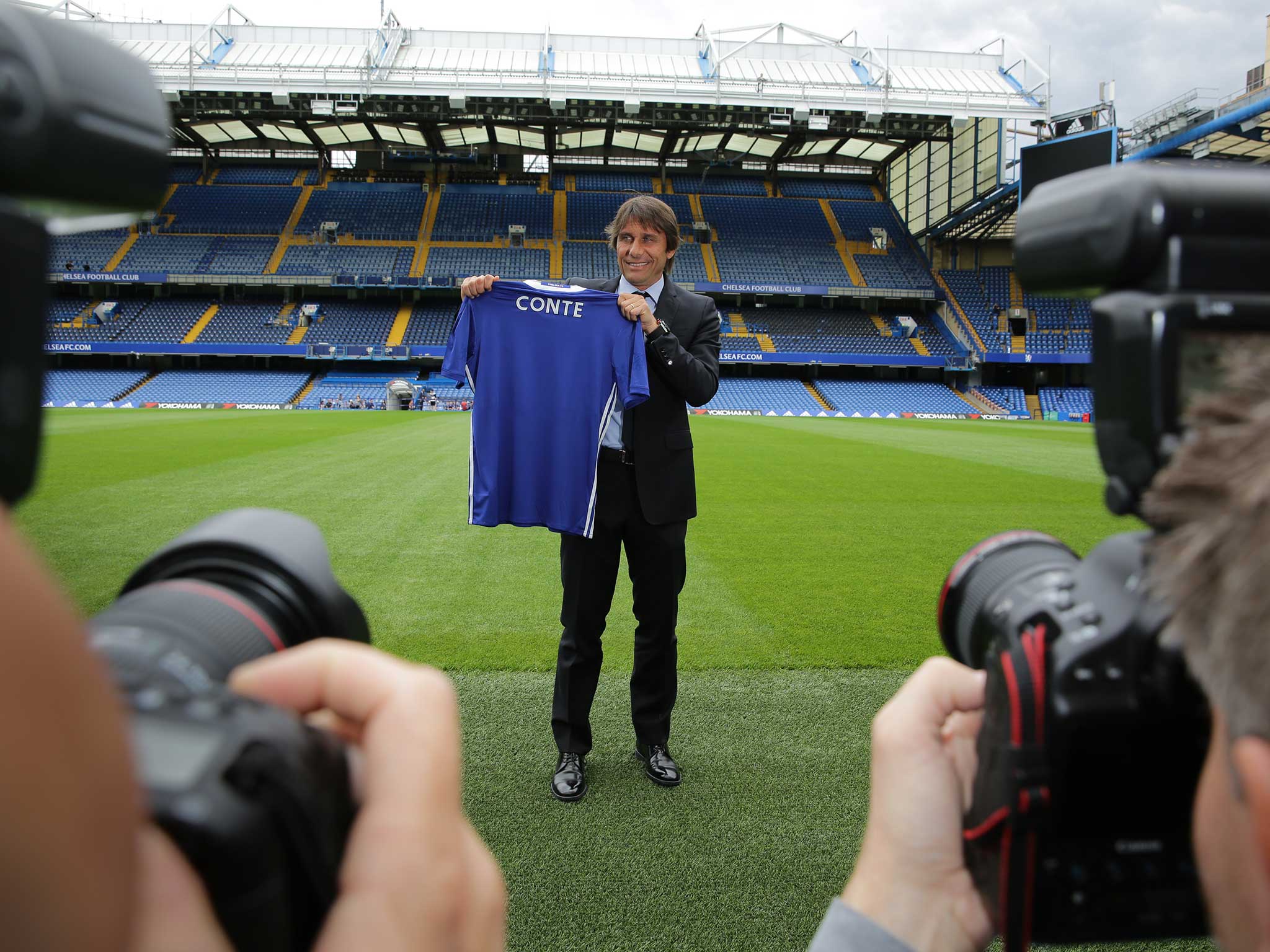 Antonio Conte poses for photographers at Stamford Bridge