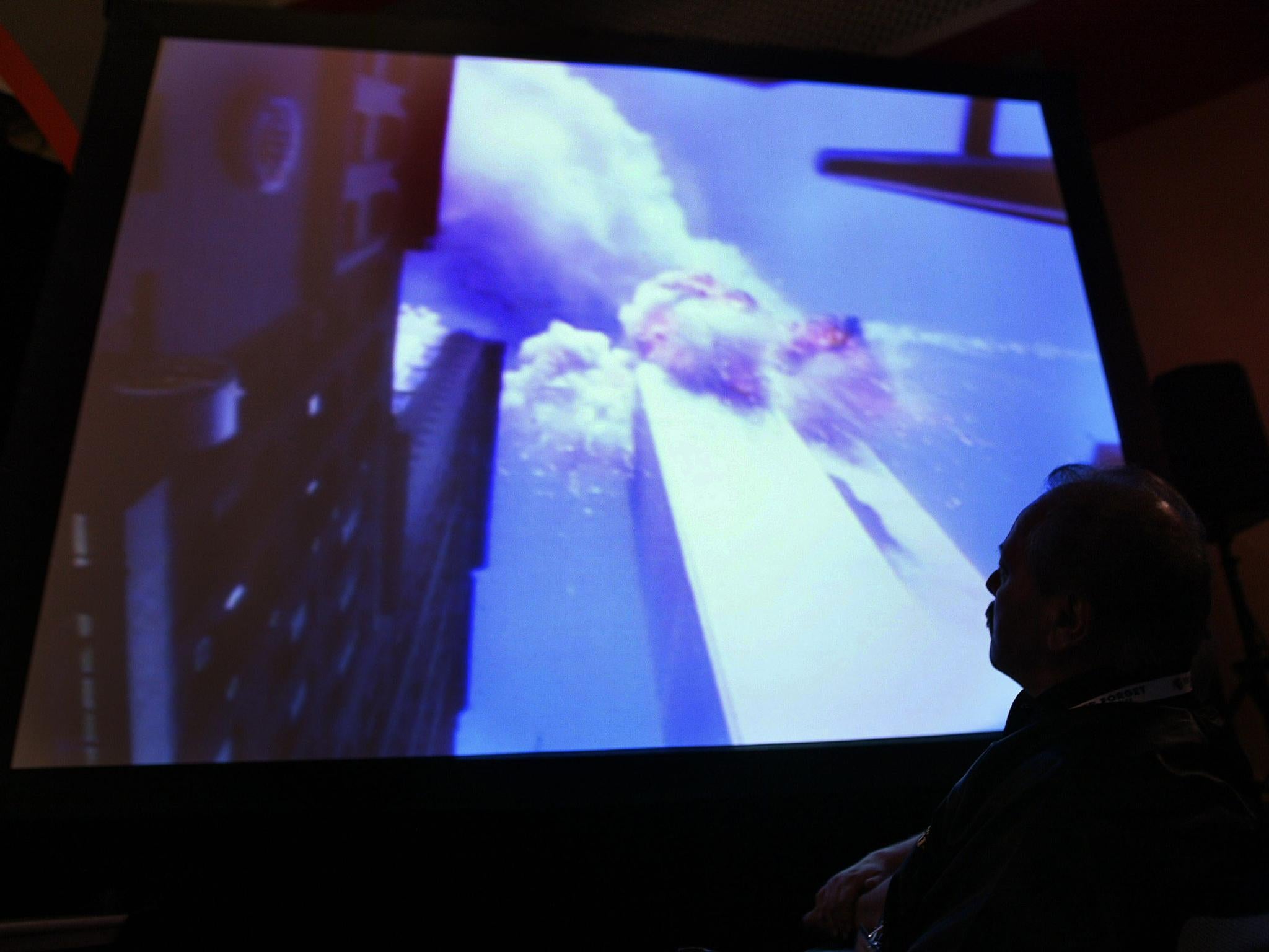Investigators and victims' families watch footage of the New York City attack during a 9/11 Commission hearing