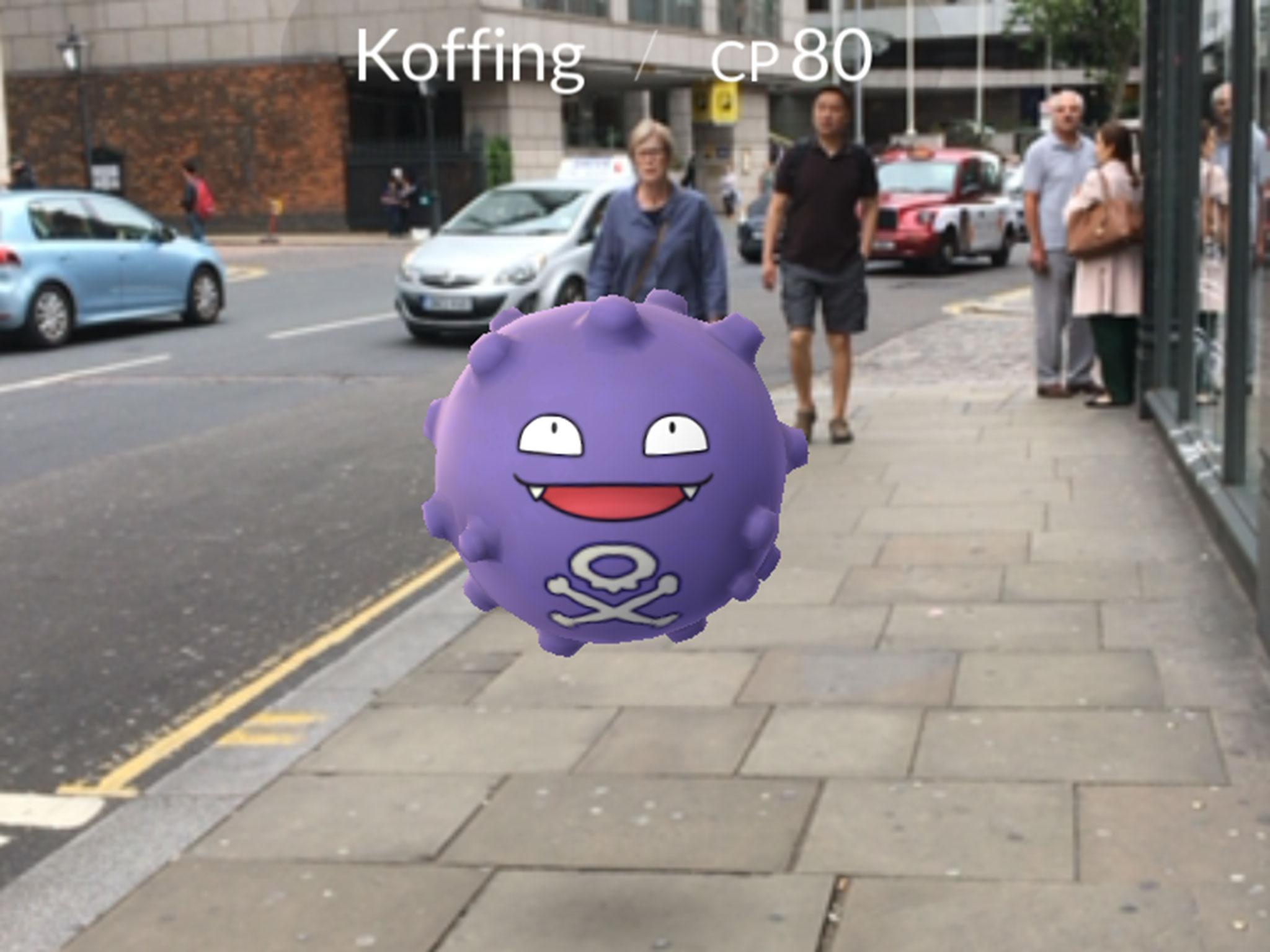 Players catch Pokemon characters which appear on the screen of a smartphone
