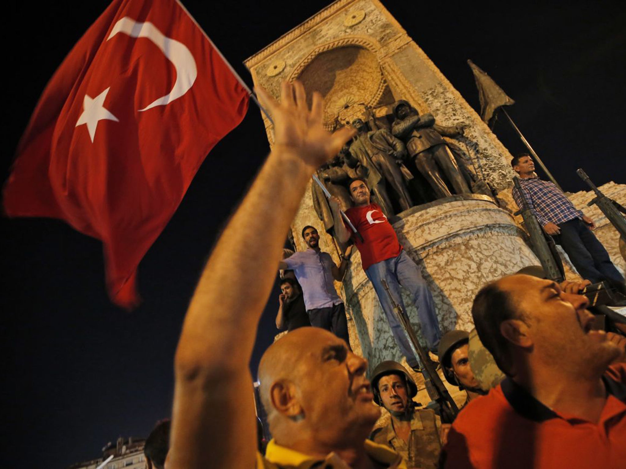 Supporters of Recep Tayyip Erdogan protest in front of soldiers in Istanbul's Taksim square