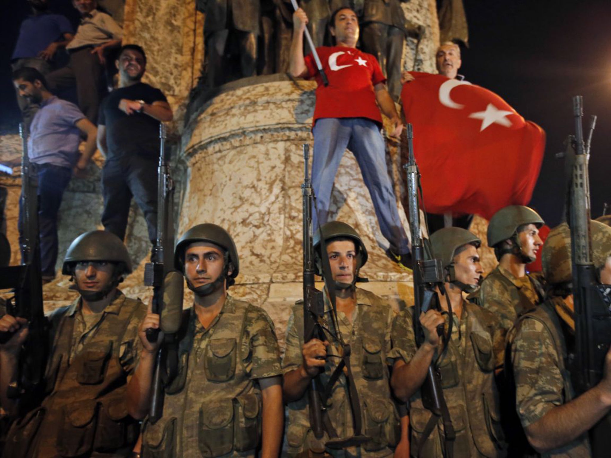 Turkish soldiers secure the area as supporters of Recep Tayyip Erdogan protest in Istanbul's Taksim square