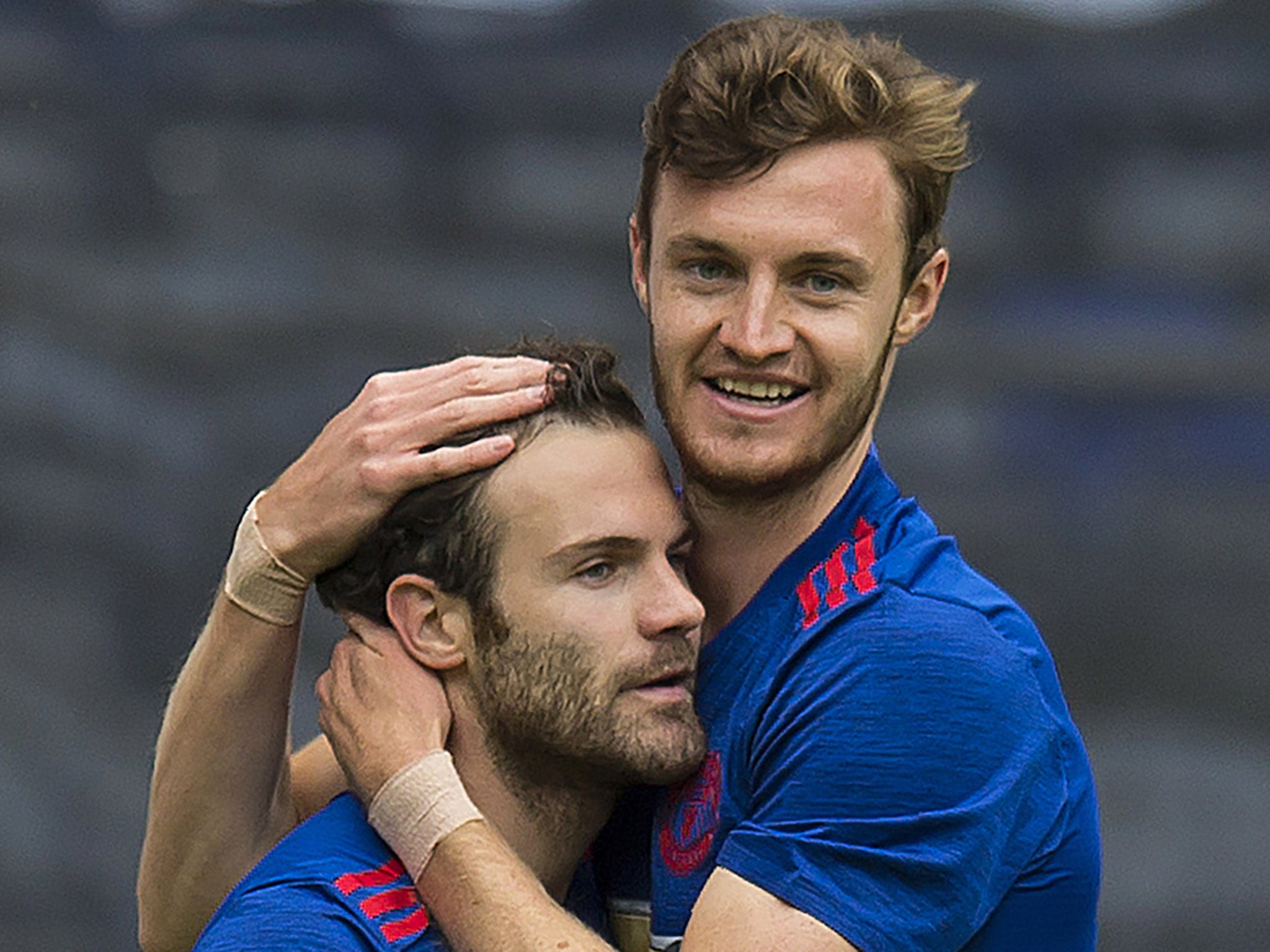 Juan Mata celebrates with Will Keane after the latter scored the opening goal