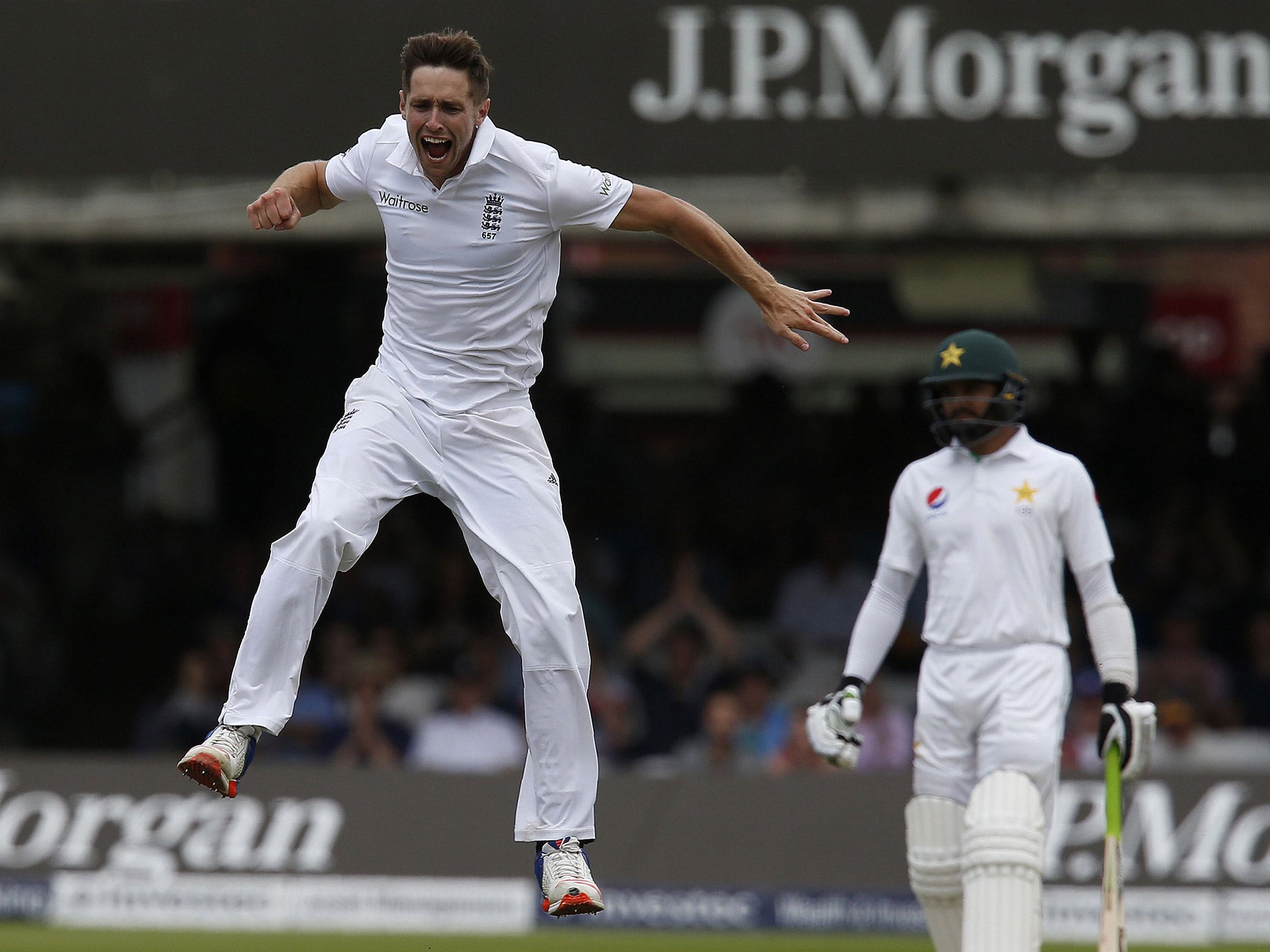 Chris Woakes celebrates taking the wicket of Shan Masood