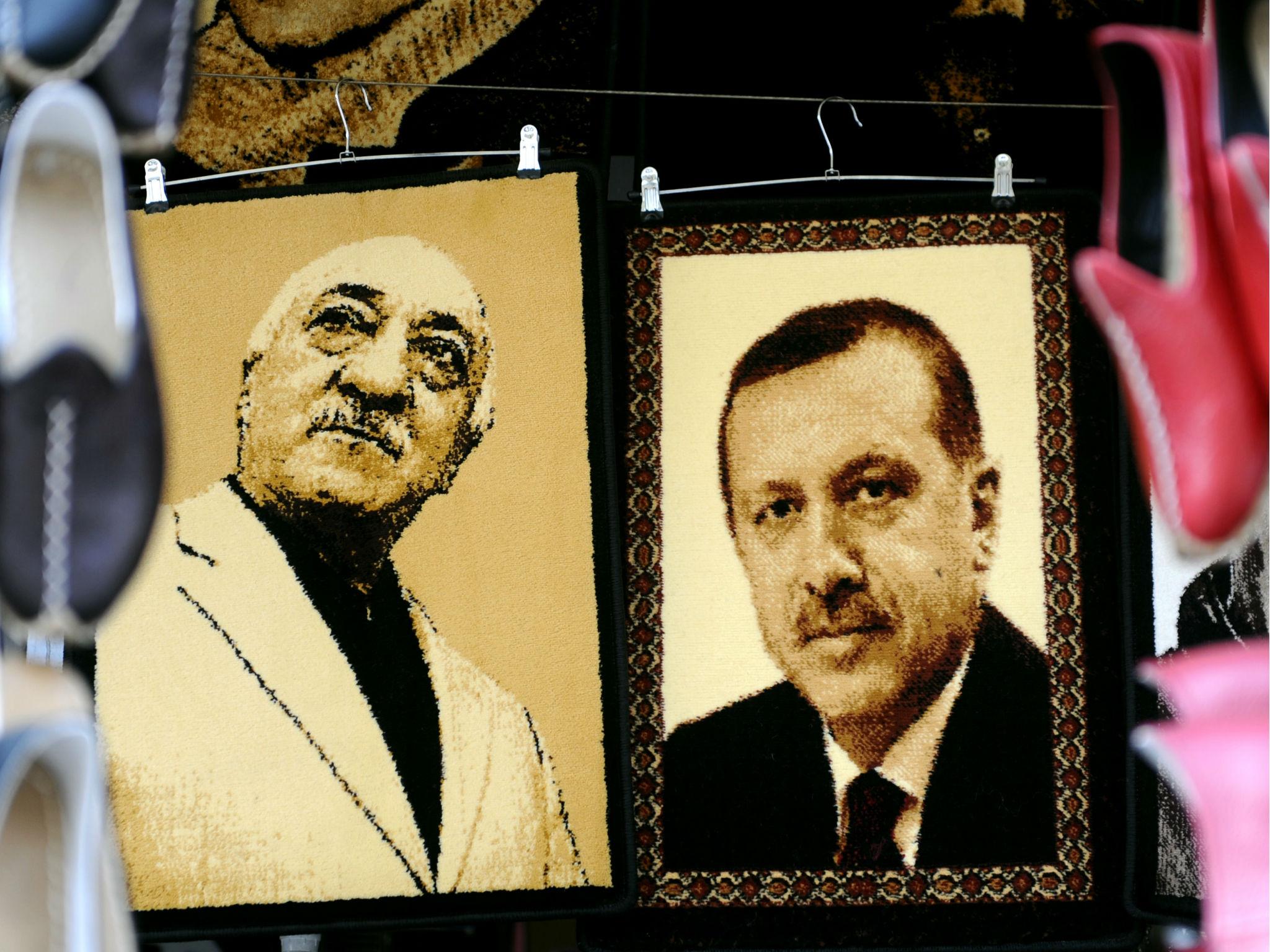 Embroidered images of United States-based Turkish cleric Fethullah Gulen (L) and Turkey's Prime Minister Recep Tayyip Erdogan (R) are displayed in a shop in the Gaziantep market on January 17, 2014