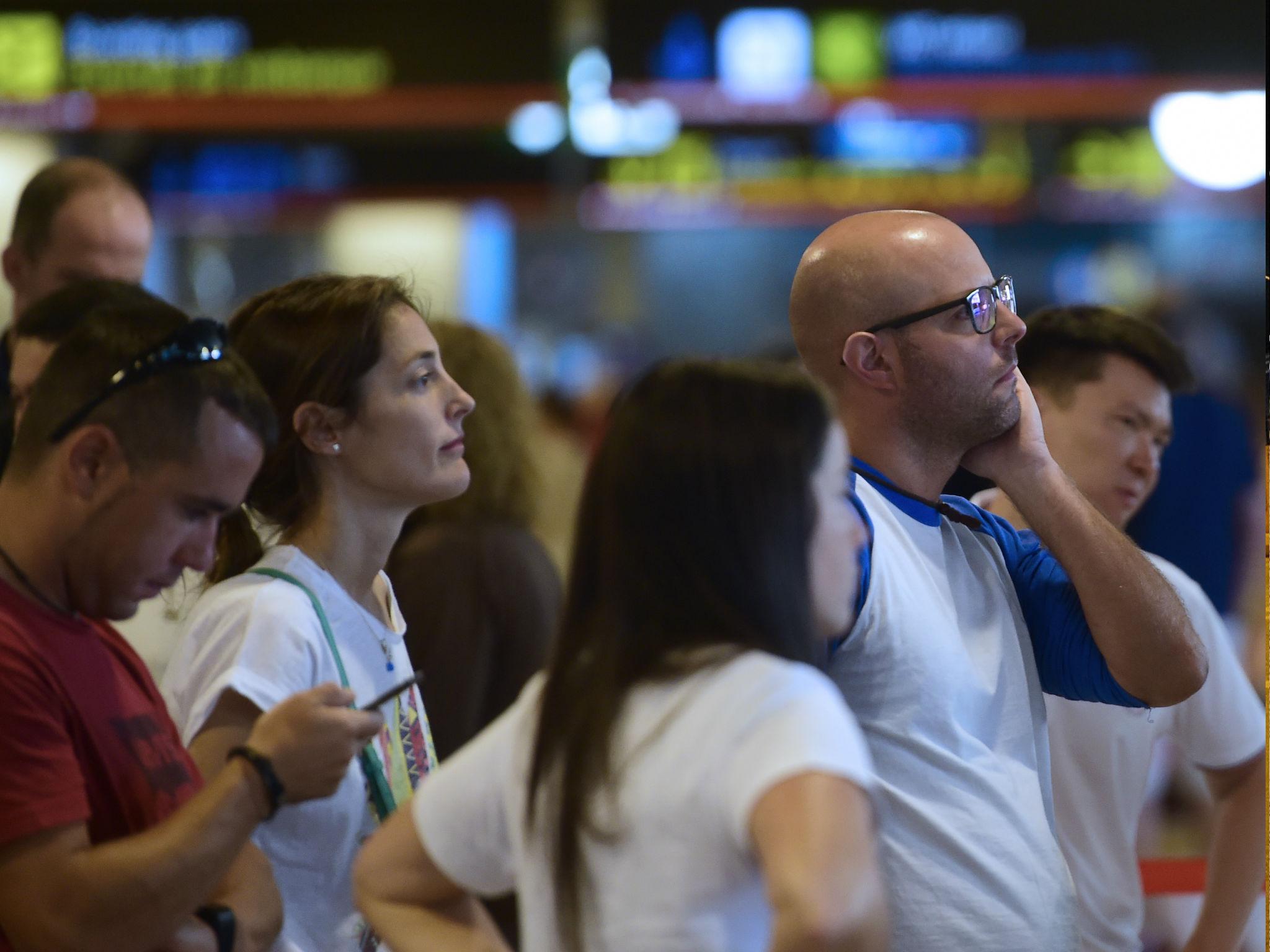 People wait at Turkish Airlines desk at Adolfo Suarez airport in Barajas, near Madrid on July 16, 2016 as Turkish Airlines cancelled their flights following an attempted coup in Turkey.