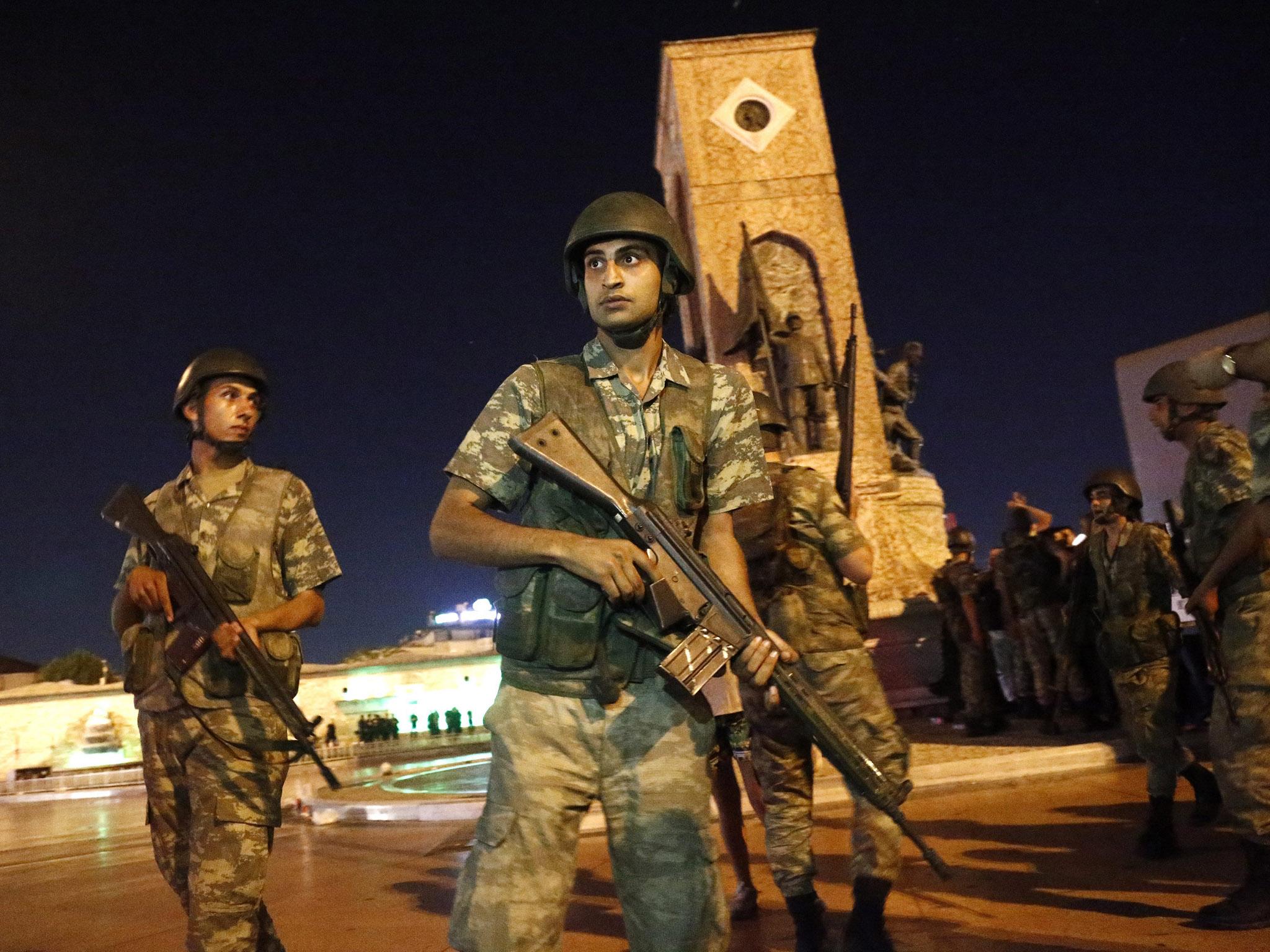 Turkish soldiers stand guard at the Taksim Square in Istanbul, Turkey