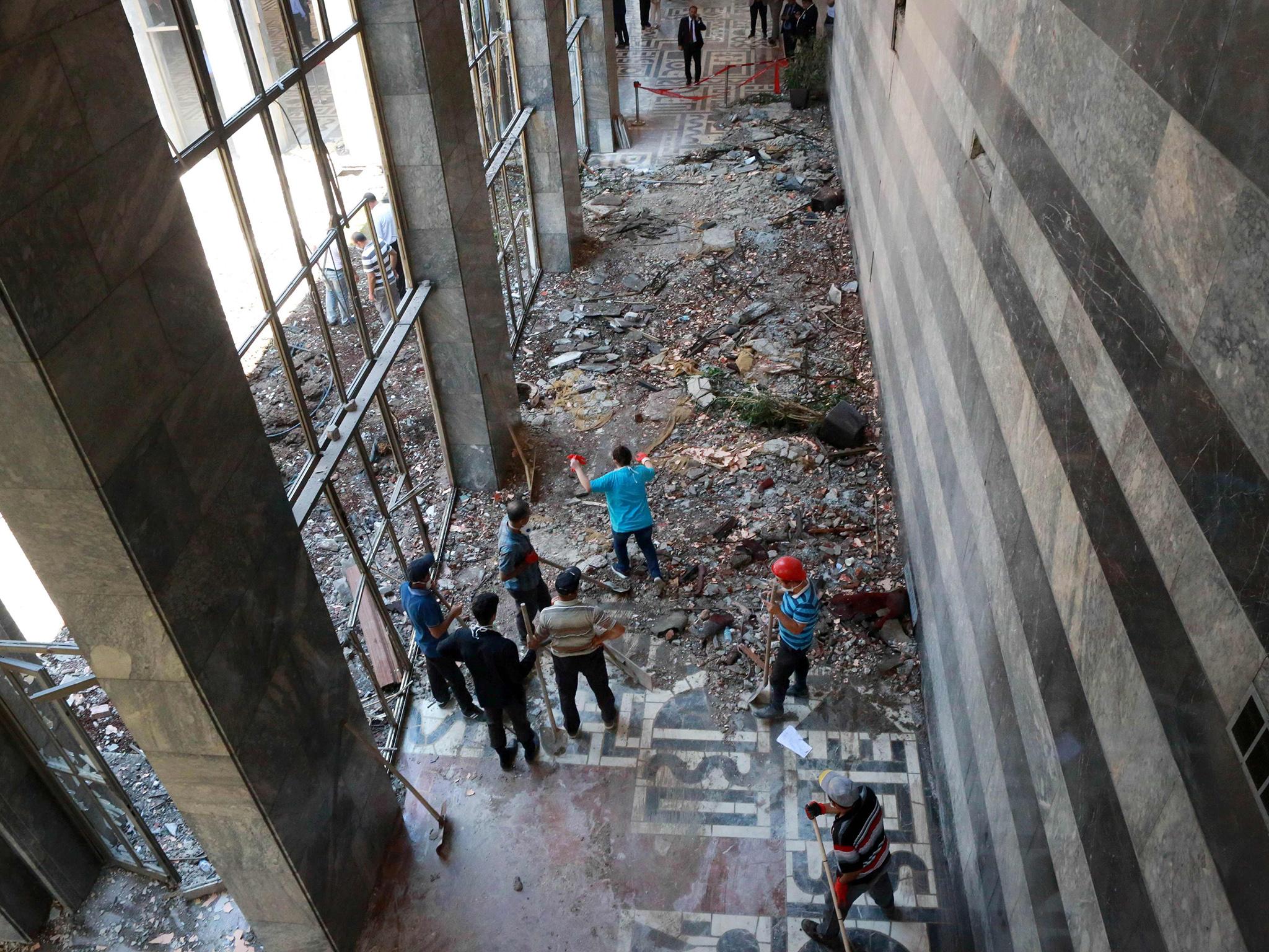 Workers inspect and clear debris after the Grand National Assembly of Turkey was bombed in Ankara.
