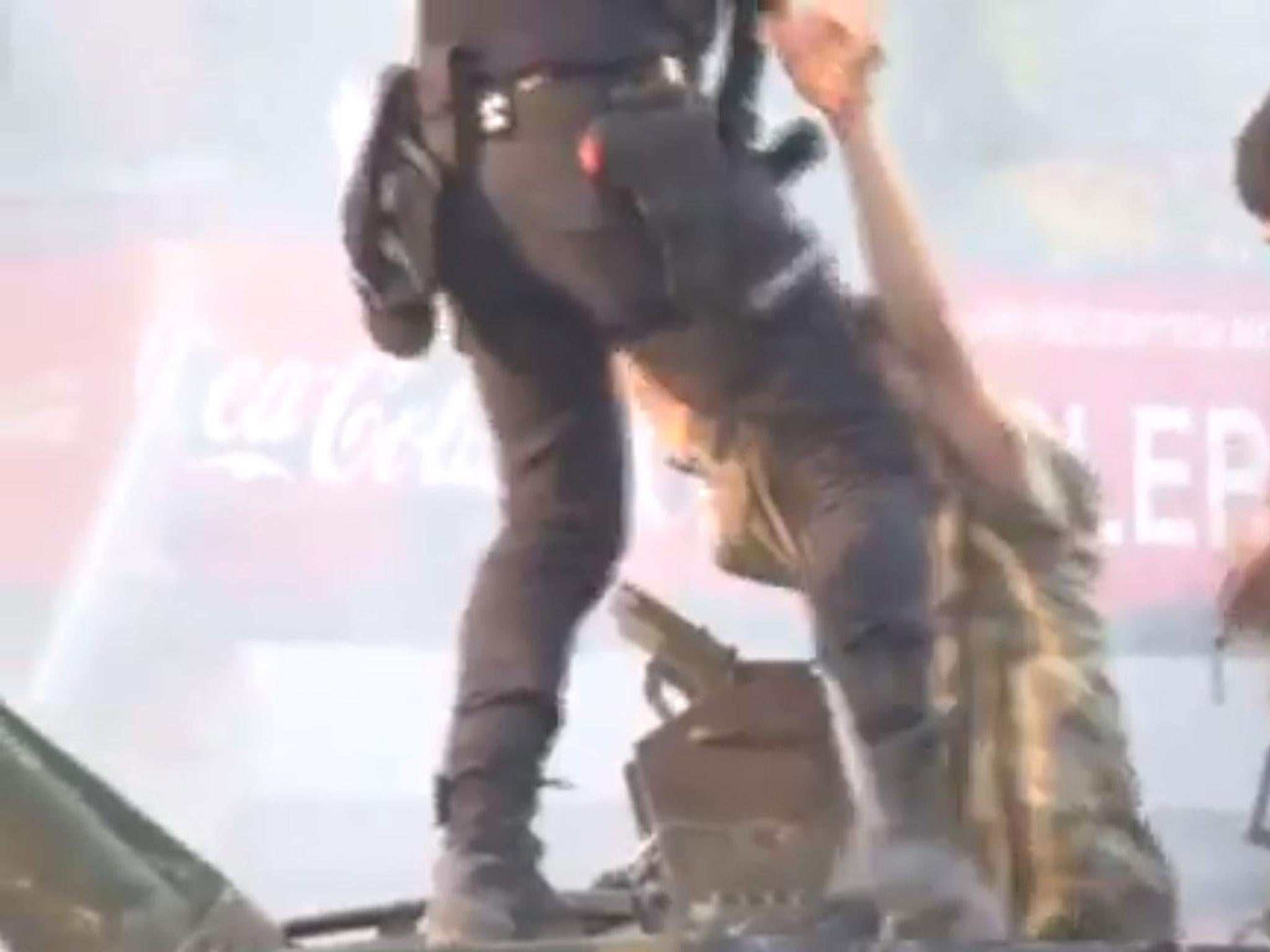 The policeman helps the soldier out of the armoured vehicle