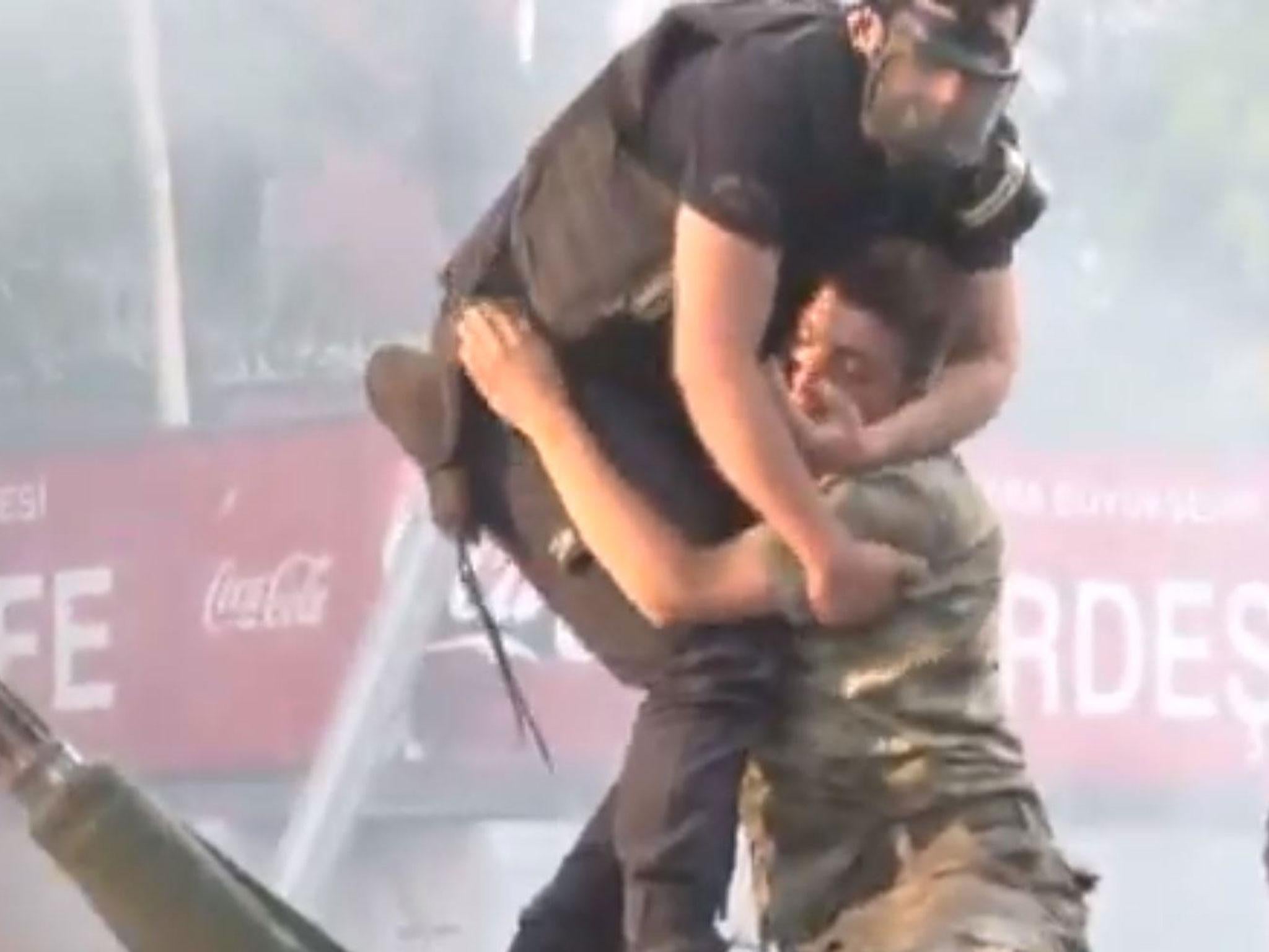 The policeman hugs the soldier
