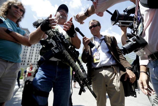 A gun rights advocates shows off his weapons on Sunday