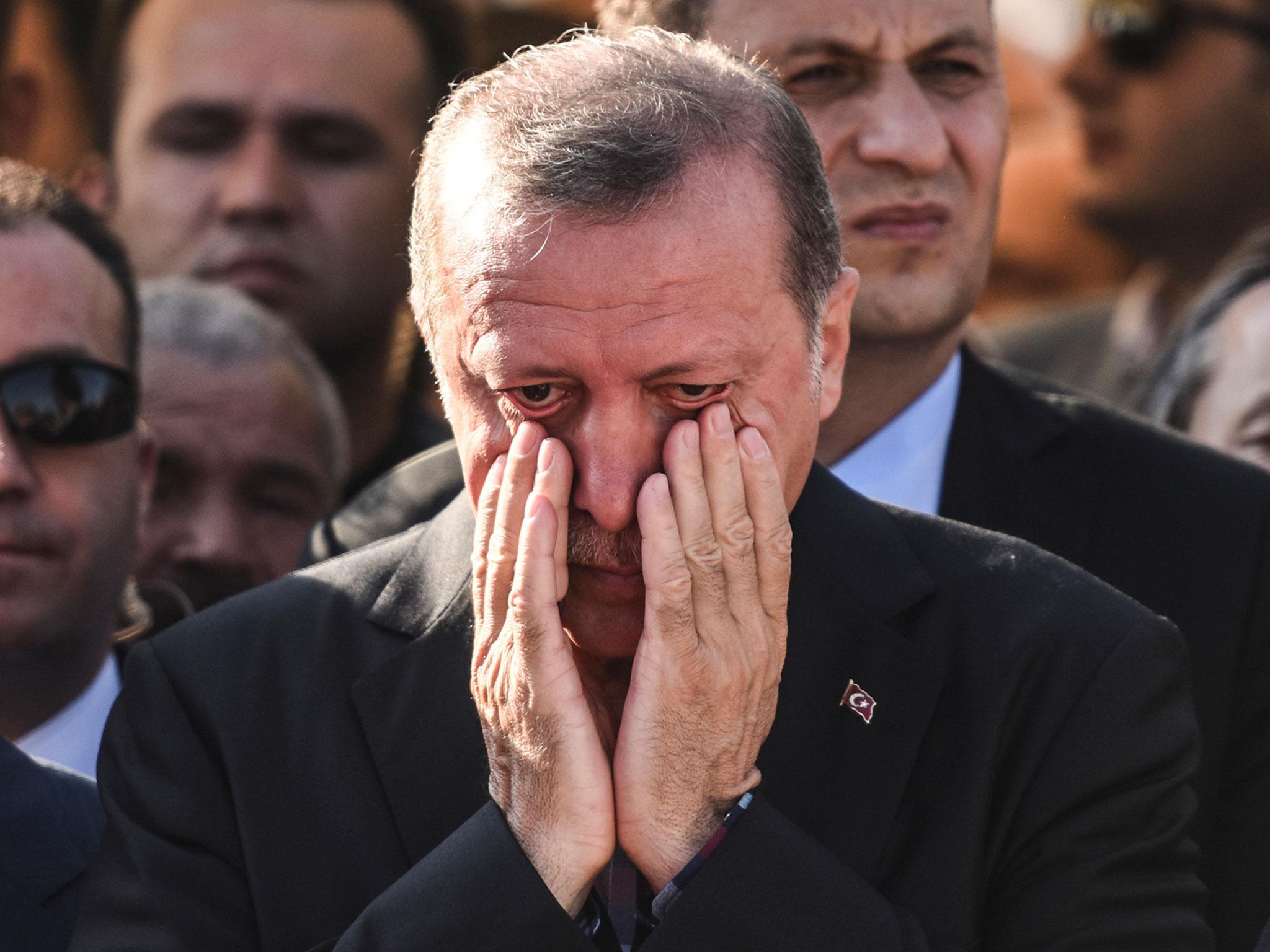 Turkey's President Recep Tayyip Erdogan reacts after attending the funeral of a victim of the coup attempt in Istanbul on 17 July, 2016