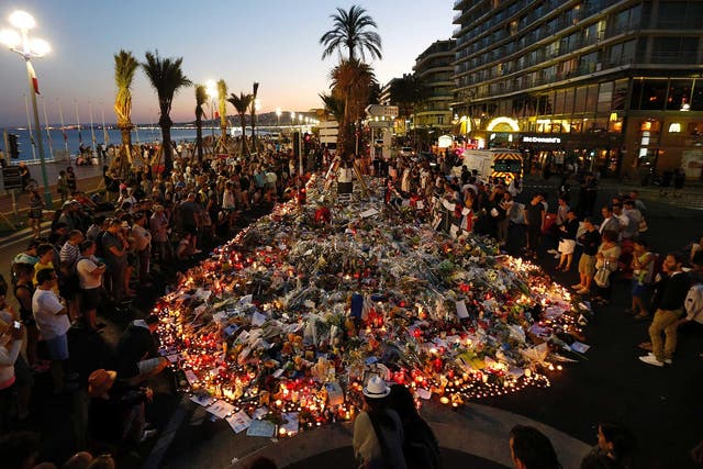 People gather at a makeshift memorial on the Promenade des Anglais in Nice, in tribute to the victims of the Bastille Day attack that left 84 dead