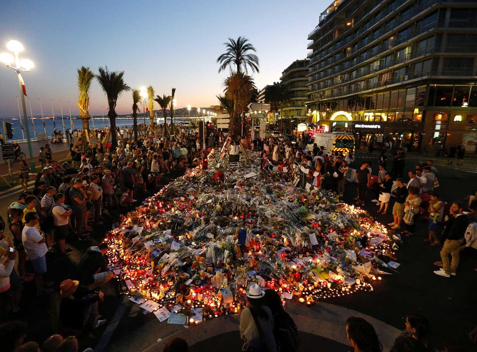 People gather at a makeshift memorial on the Promenade des Anglais in Nice, in tribute to the victims of the Bastille Day attack that left 84 dead