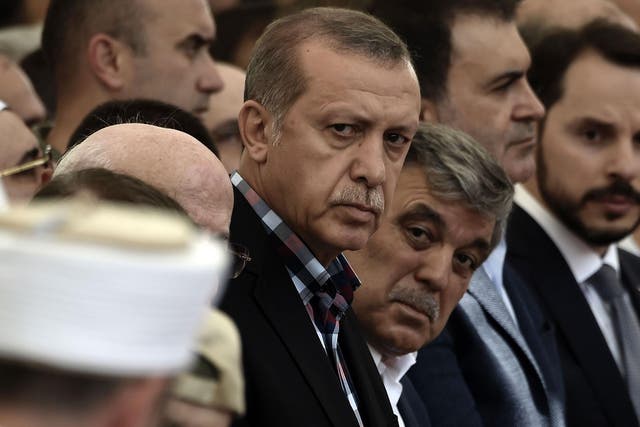 Turkish President Recep Tayyip Erdogan and former Turkish president Abdullah Gul attend the funeral of a victim of the coup attempt in Istanbul on 17 July, 2016