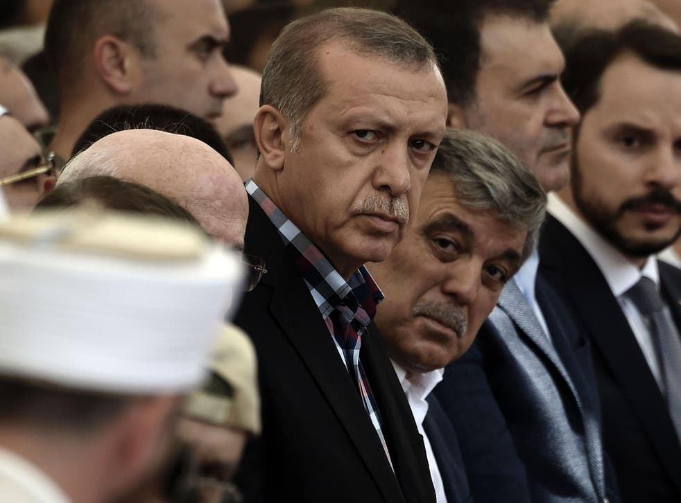 Turkish President Recep Tayyip Erdogan and former Turkish president Abdullah Gul attend the funeral of a victim of the coup attempt in Istanbul on 17 July, 2016