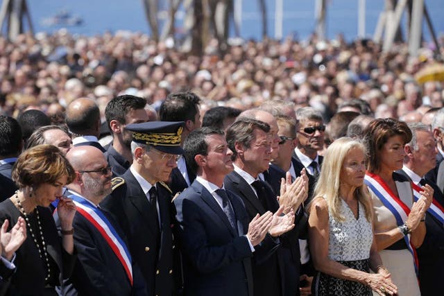 French Prime Minister Manuel Valls (centre) standing at the Monument du Centenaire during a minute's silence for the Nice terror attack victims