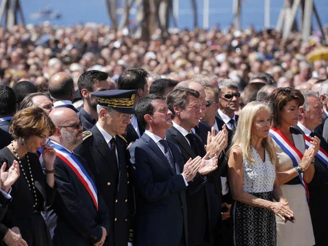 French Prime Minister Manuel Valls (centre) standing at the Monument du Centenaire during a minute's silence for the Nice terror attack victims