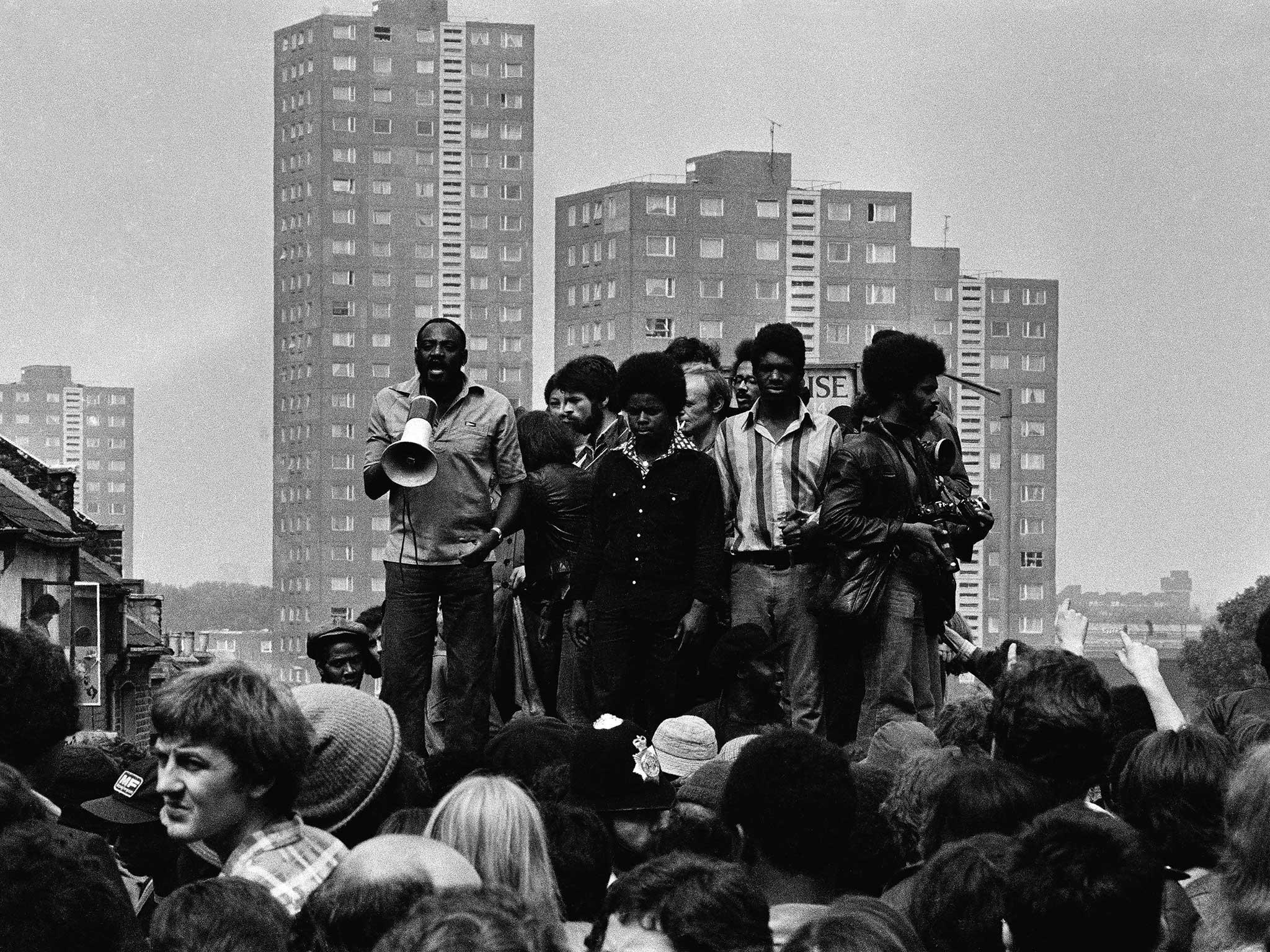 Civil liberties activist Darcus Howe addresses the 'Anti-Anti Mugging March' from the roof of a public toilet