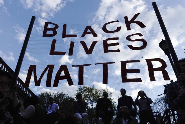 Protesters hold up a Black Lives Matter banner
