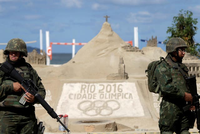 Brazilian Army Forces soldiers patrol on Copacabana beach ahead of the 2016 Rio Olympic games in Rio de Janeiro, Brazil, July 18, 2016