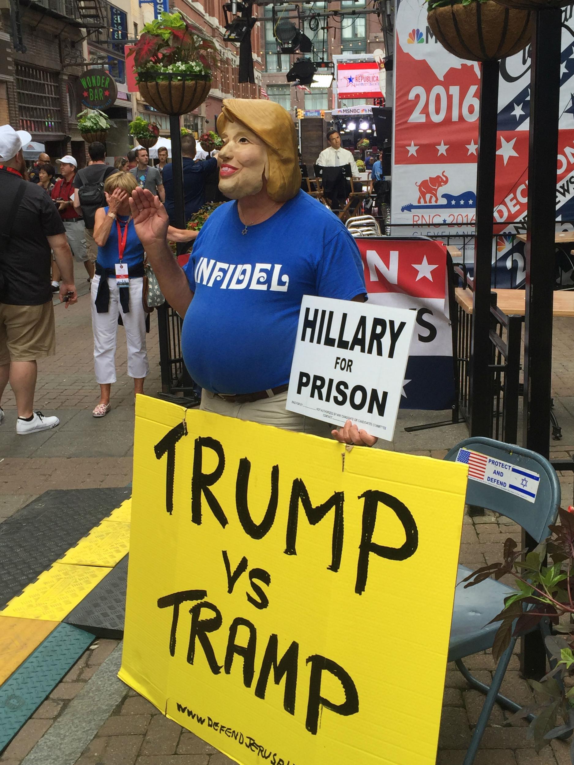 A Trump supporter scorns Hillary Clinton outside convention arena
