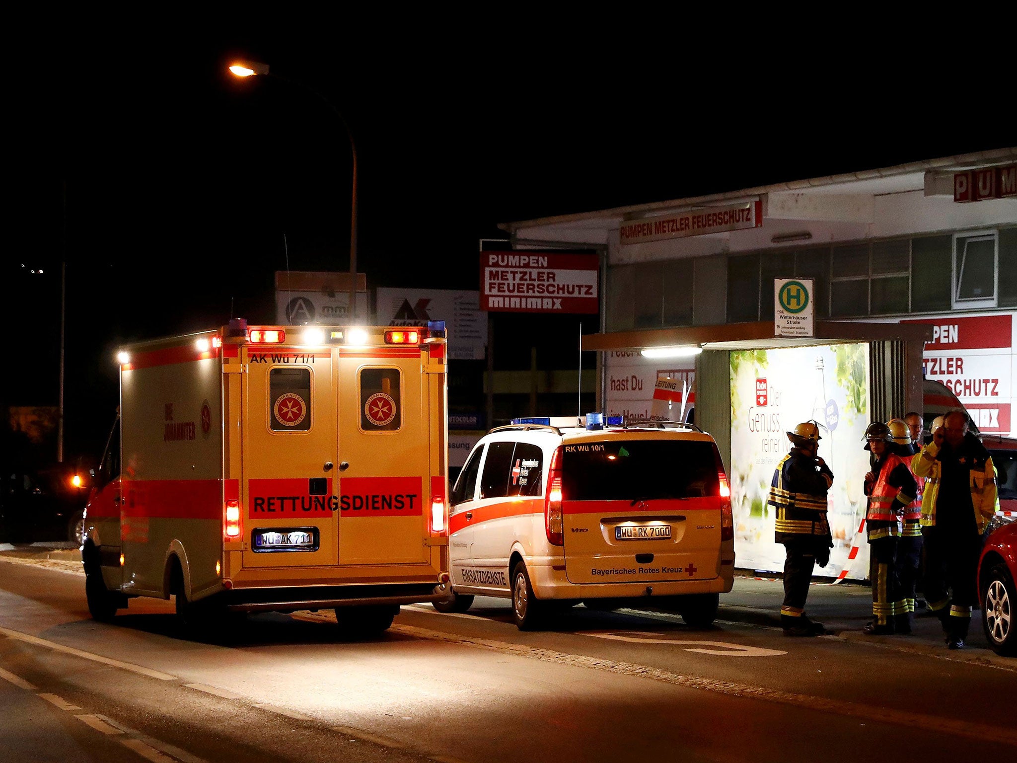 German emergency services work in the area where a man with an axe attacked passengers on a train