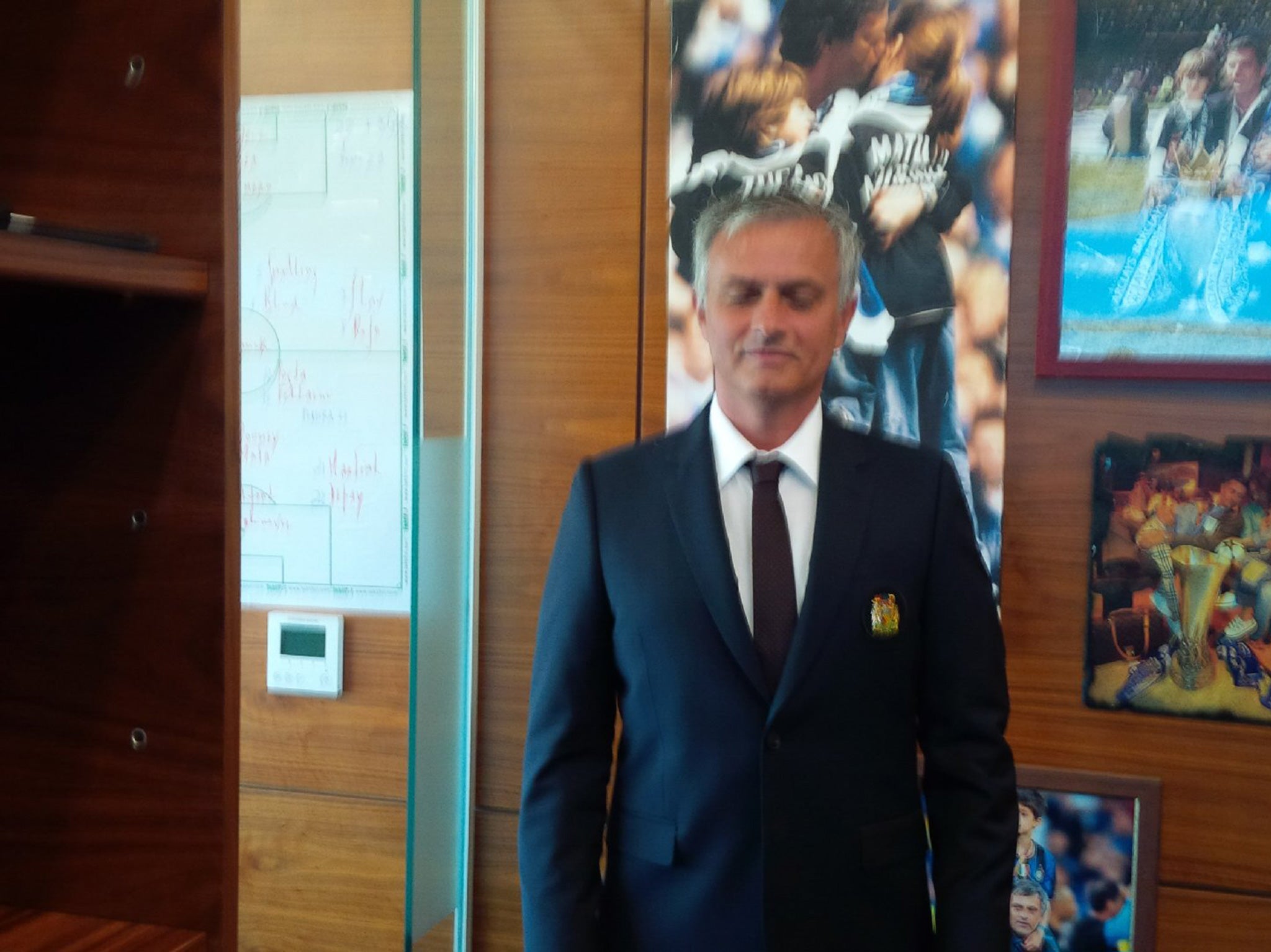 Mourinho posing in his club suit prior to United's flight to China