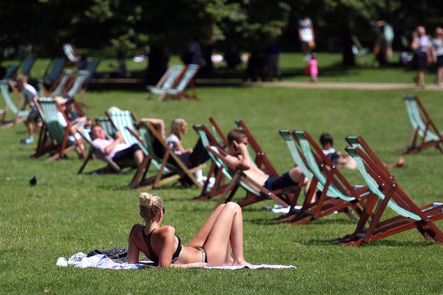 Sunbathers enjoy the hot weather in St James' Park in central London