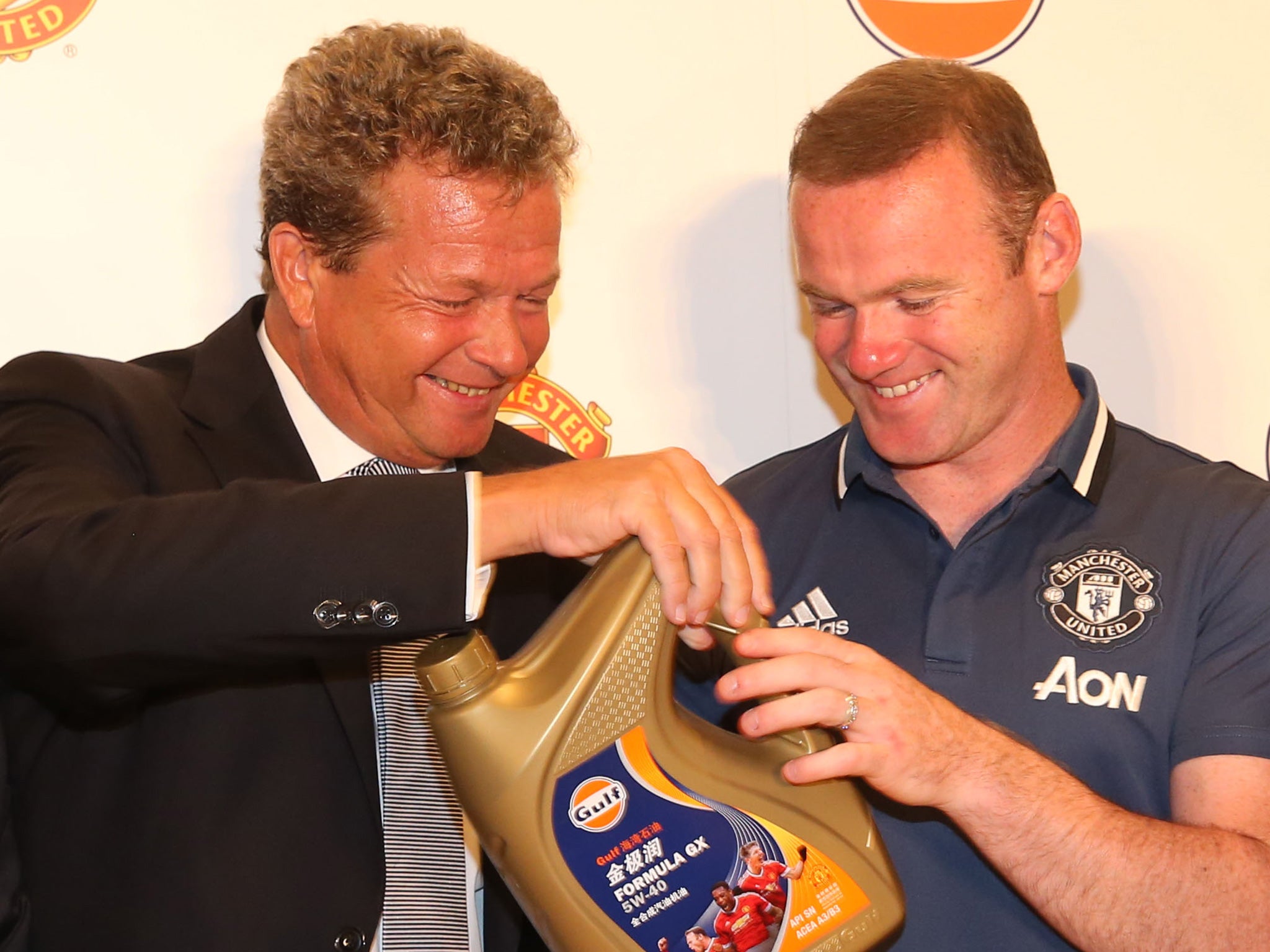 Rutten, vice-president of Gulf Oil, introduces Rooney to his product