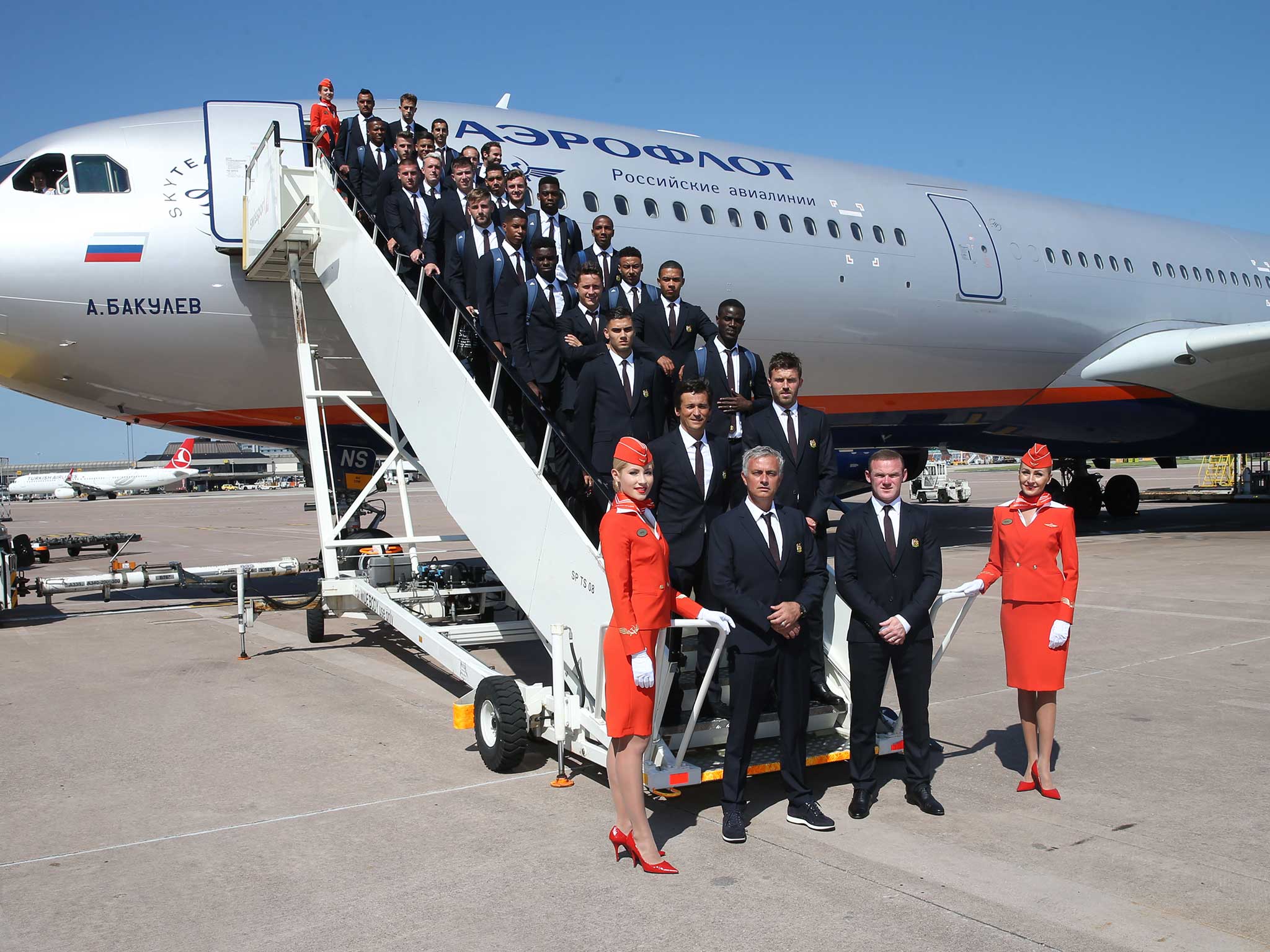 Jose Mourinho and his Manchester United pose before flying to China