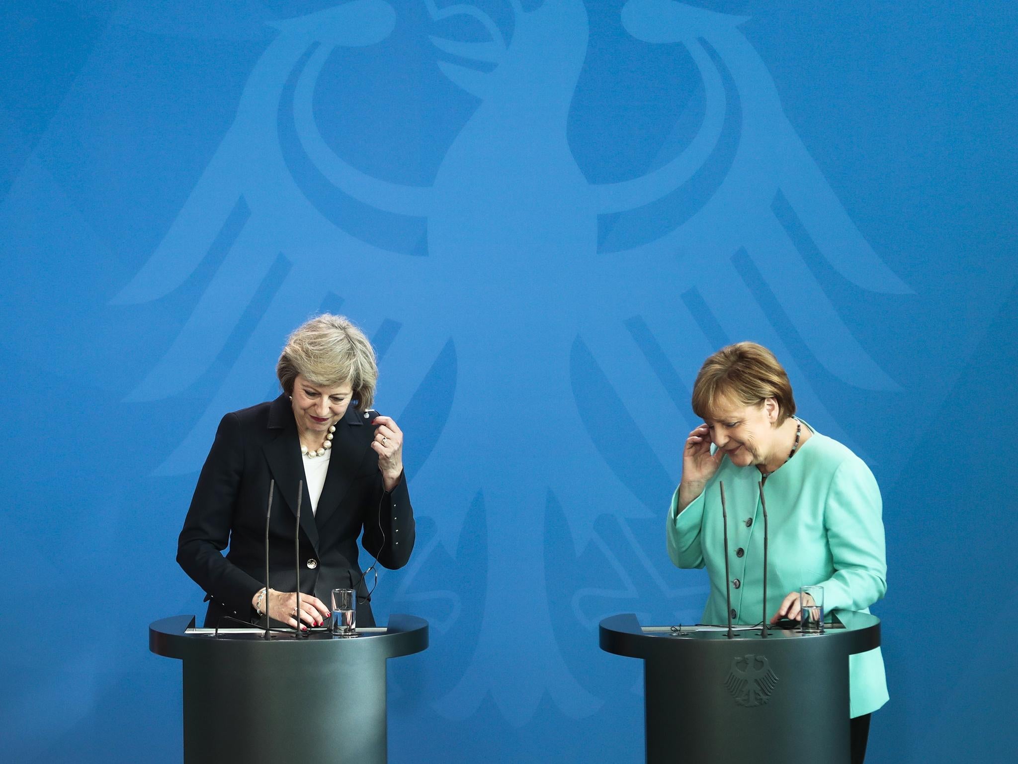 Theresa May, left, and Angela Merkel, brief the media at a news conference at the chancellery in Berlin yesterday