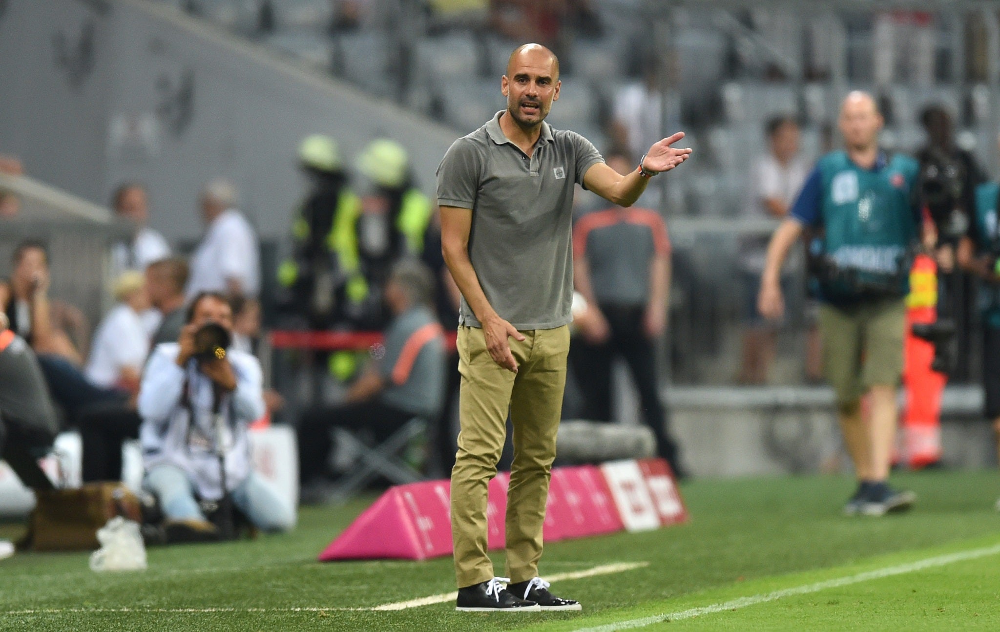 Pep Guardiola gestures from the sideline during Manchester City's pre-season friendly with Bayern Munich