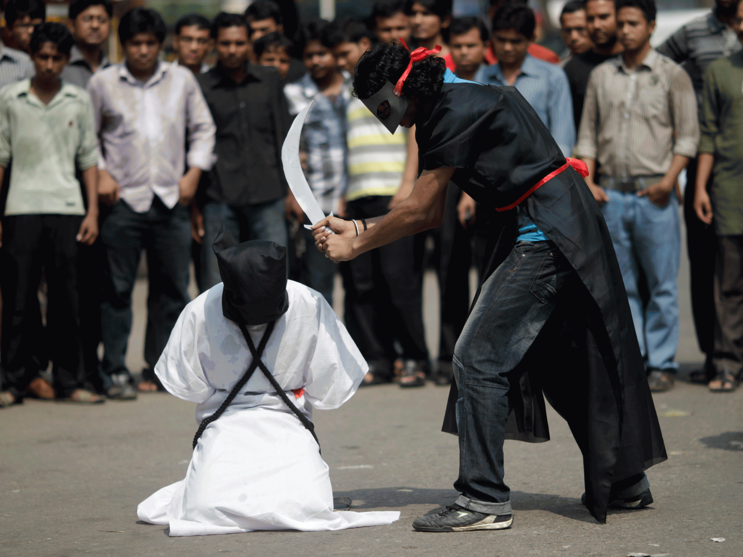 Protesters against the beheading of foreign workers in Saudi Arabia stage a mock beheading