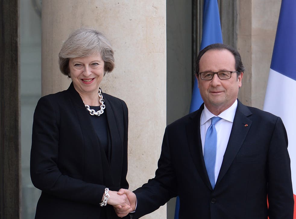  French President Francois Hollande (right) greets Theresa May at the Elysee Palace
