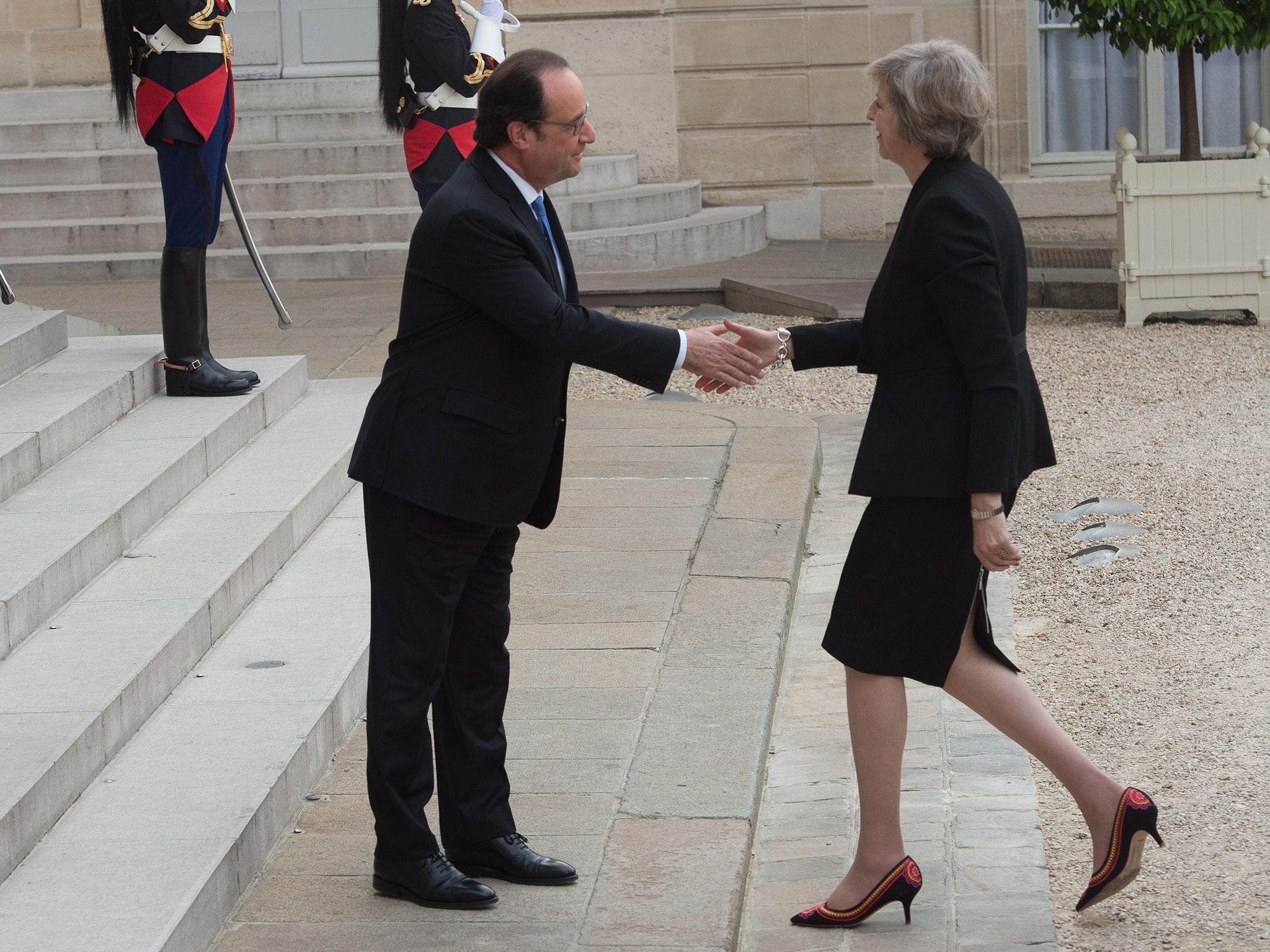 Francois Hollande greets Theresa May at the Elysee Palace yesterday