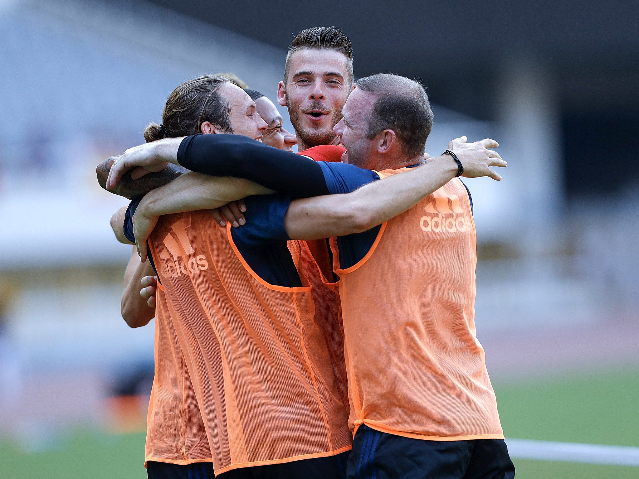 Manchester United players embrace during a training session on their pre-season tour of China