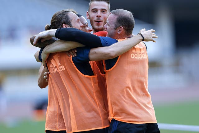 Manchester United players embrace during a training session on their pre-season tour of China