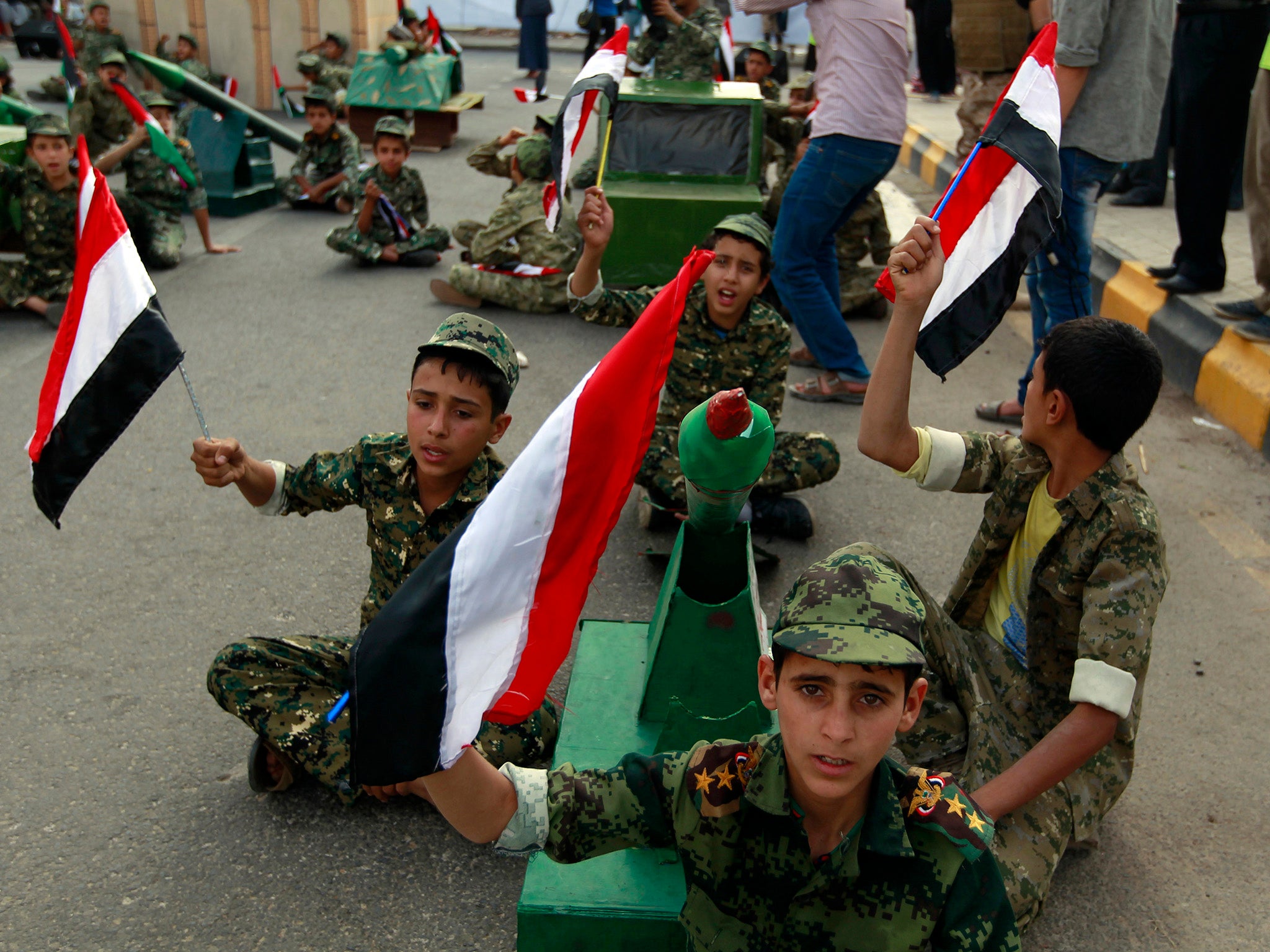 Yemen children waving national flags at rally in support of the Houthi rebels on Quds day in the capital Sanaa