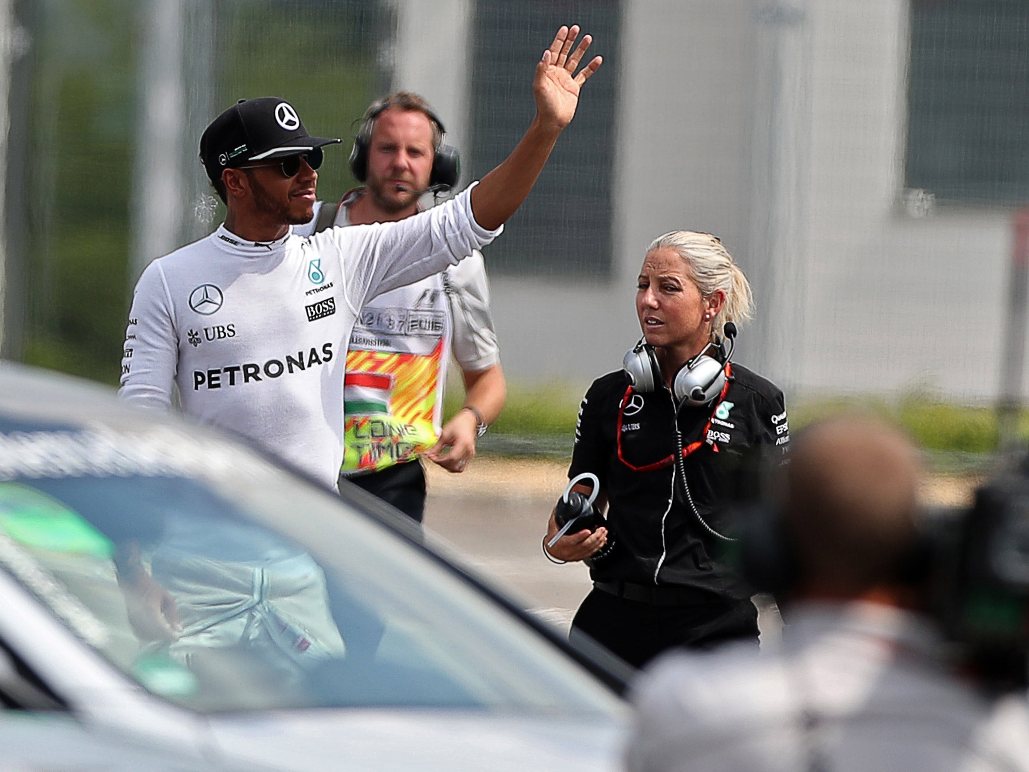 Lewis Hamilton waves to the crowd to show he's unscathed after his crash