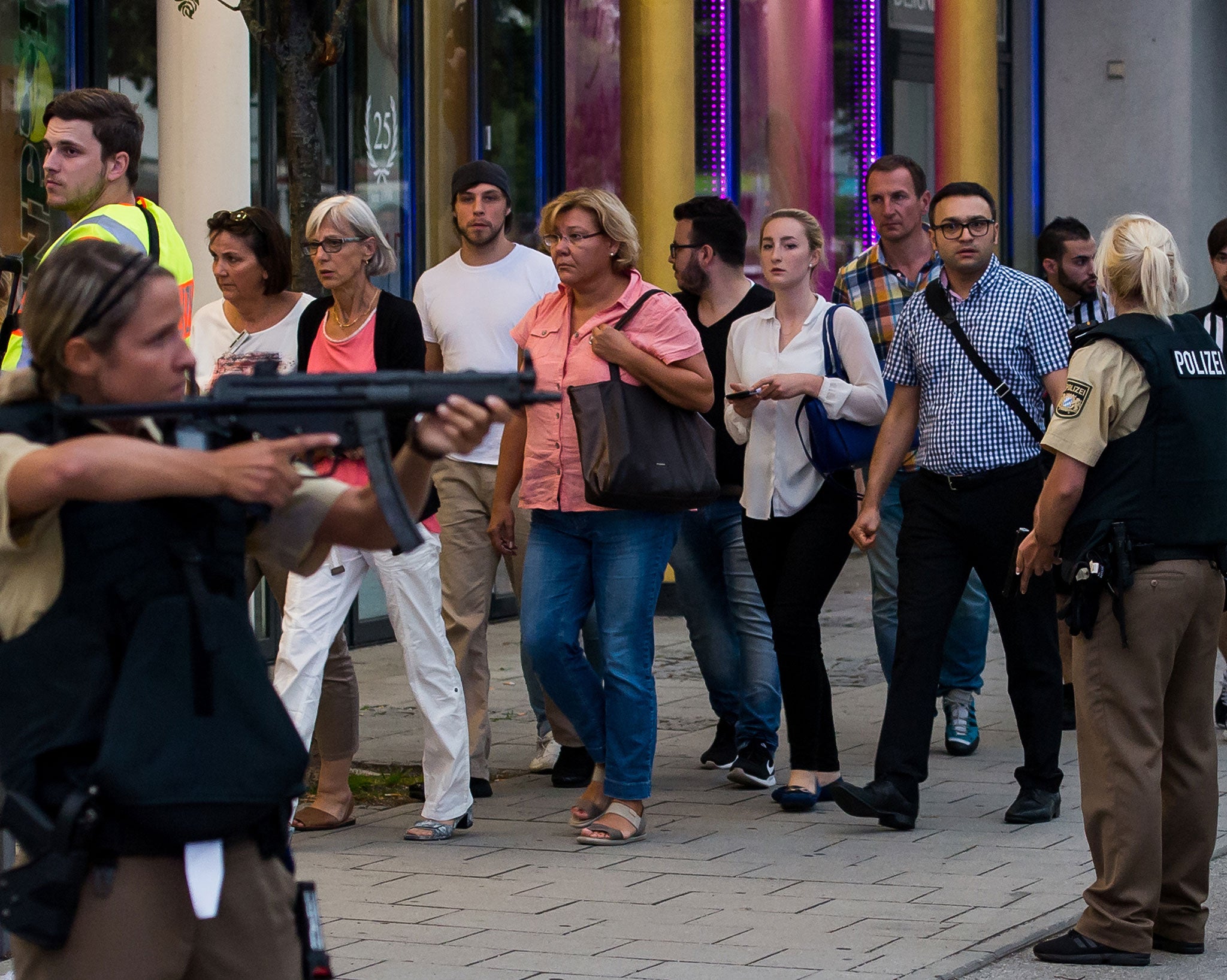 German police escort people from the Munich shopping centre that came under attack