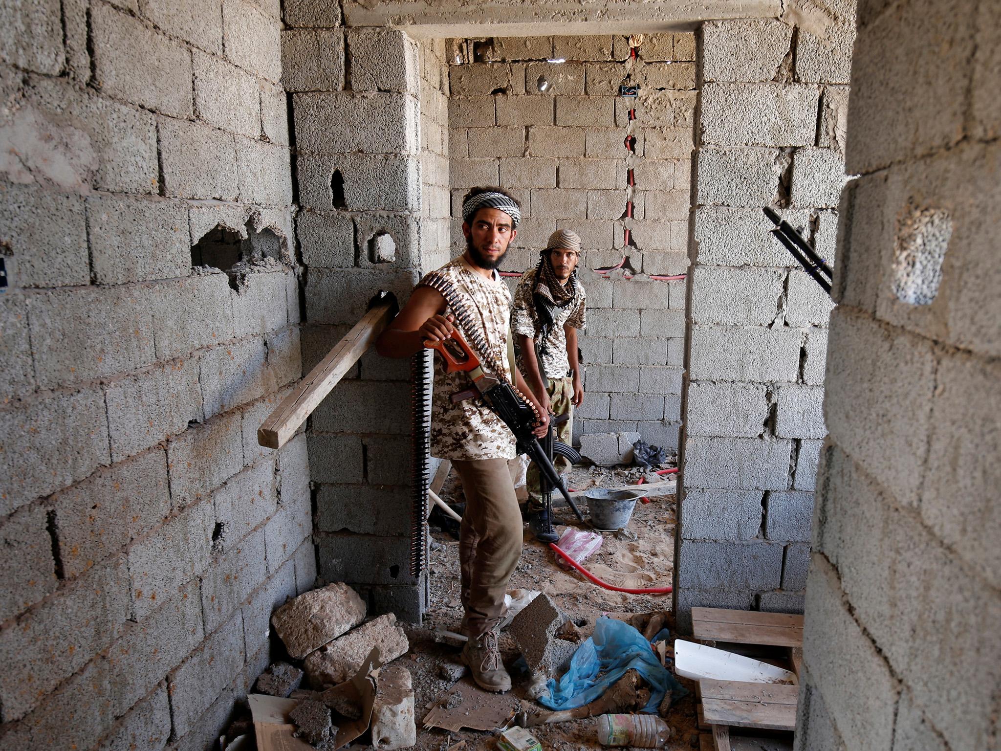&#13;
Fighters take cover in a house during a battle with Isis fighters &#13;