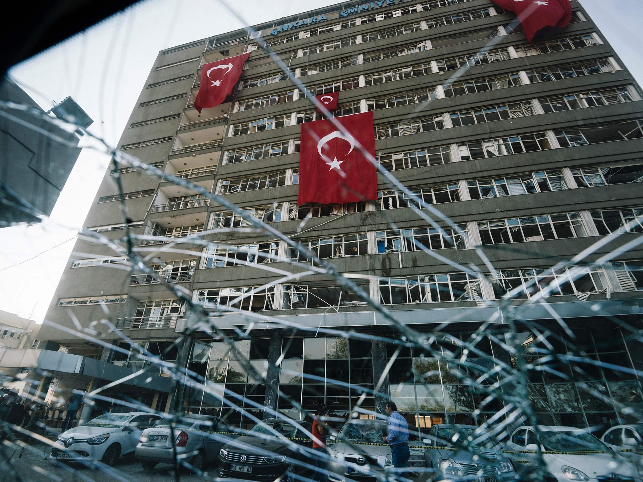 Turkish flags hanging from the facade of the damaged Ankara police headquarters after it was bombed during the failed 15 July coup attempt
